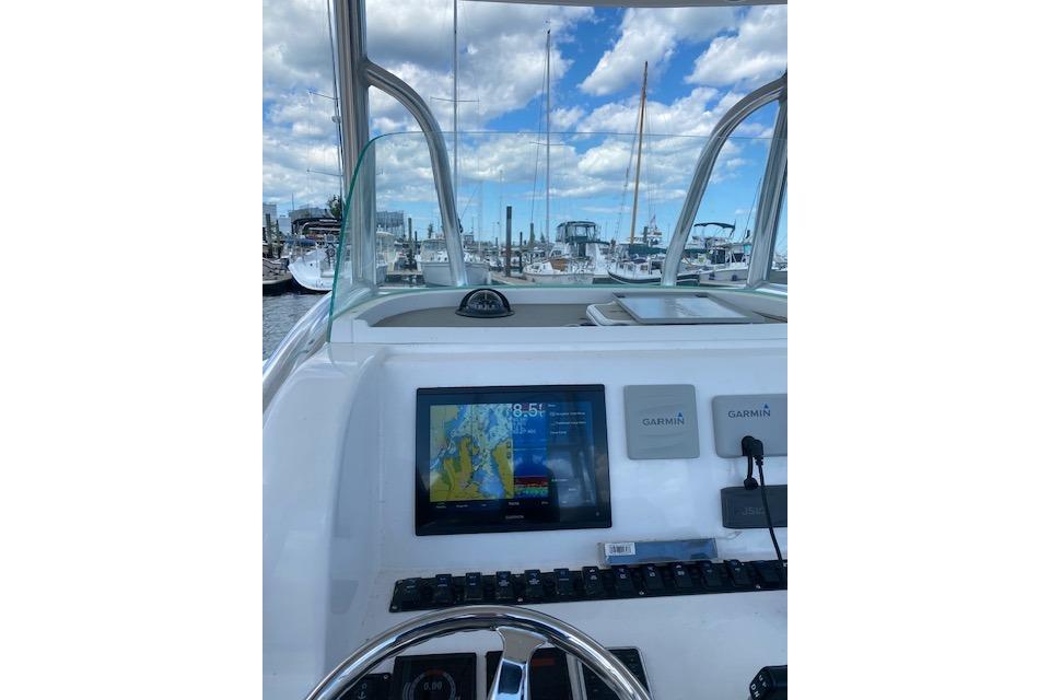 2020 Twin Vee 260 CC SE boat dashboard with Garmin navigation system at marina.