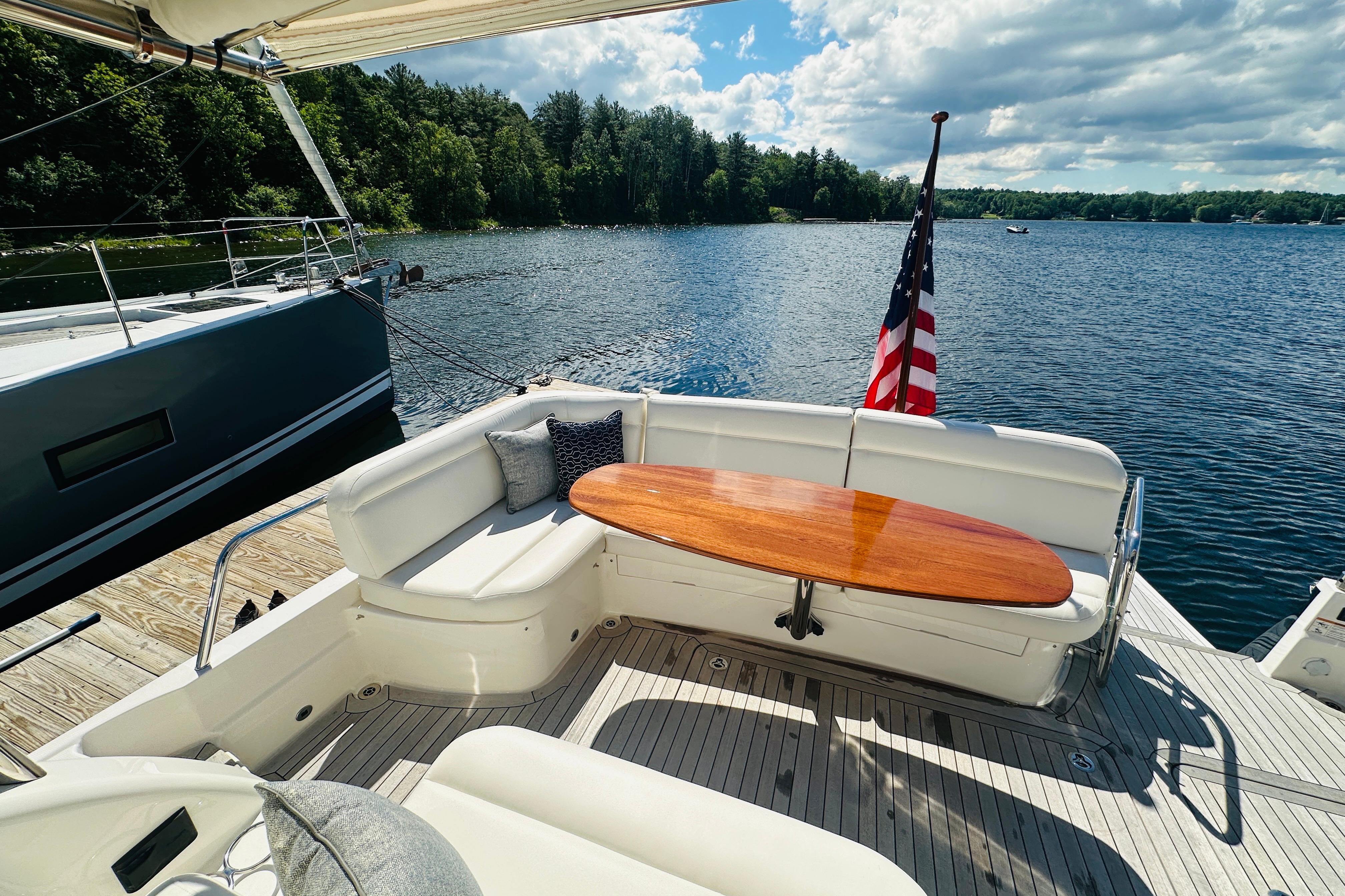 2025 Sabre 48 Salon Express yacht with elegant seating and scenic lake view.