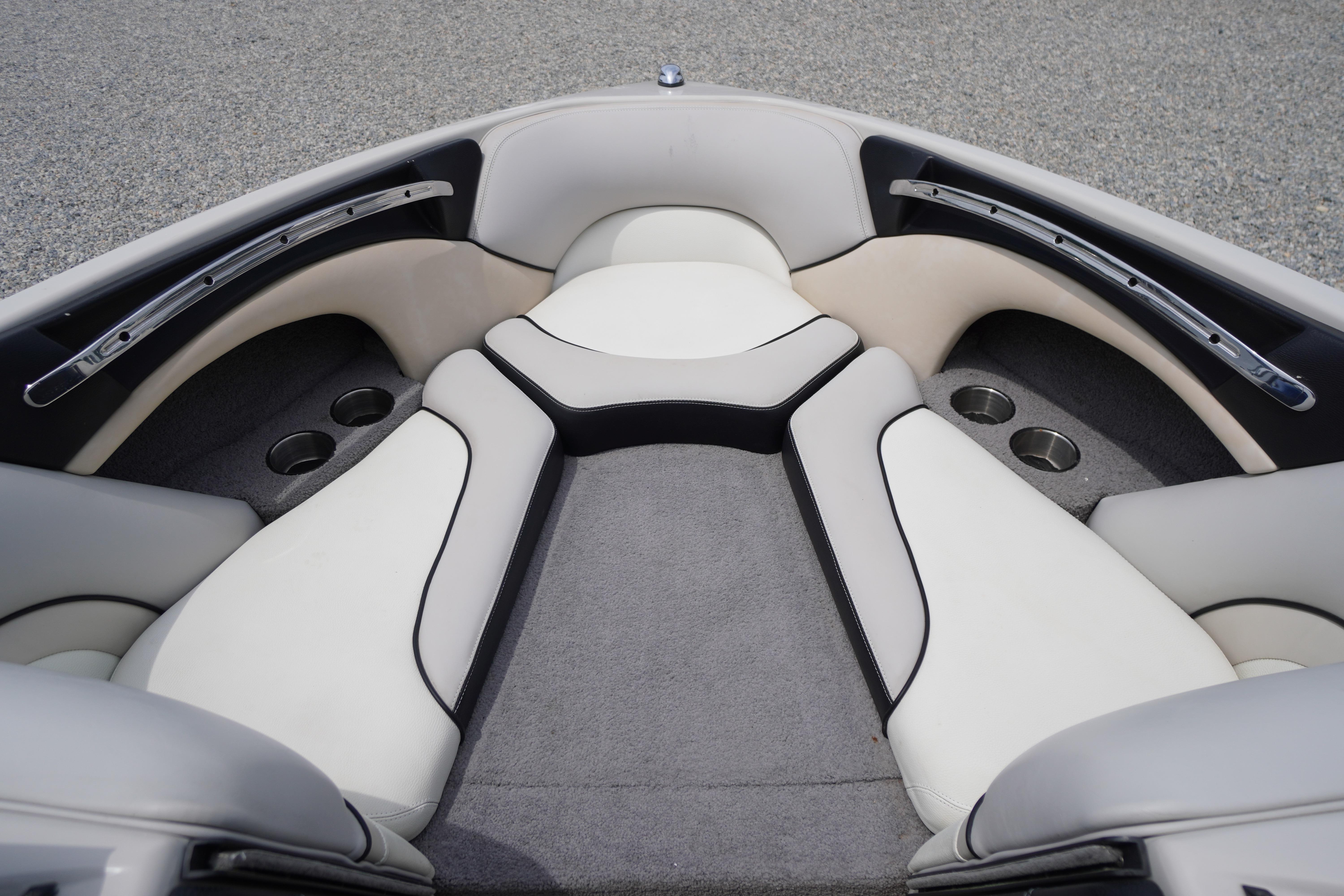 2011 Malibu Wakesetter 21 VLX boat interior with cushioned seating and cup holders.