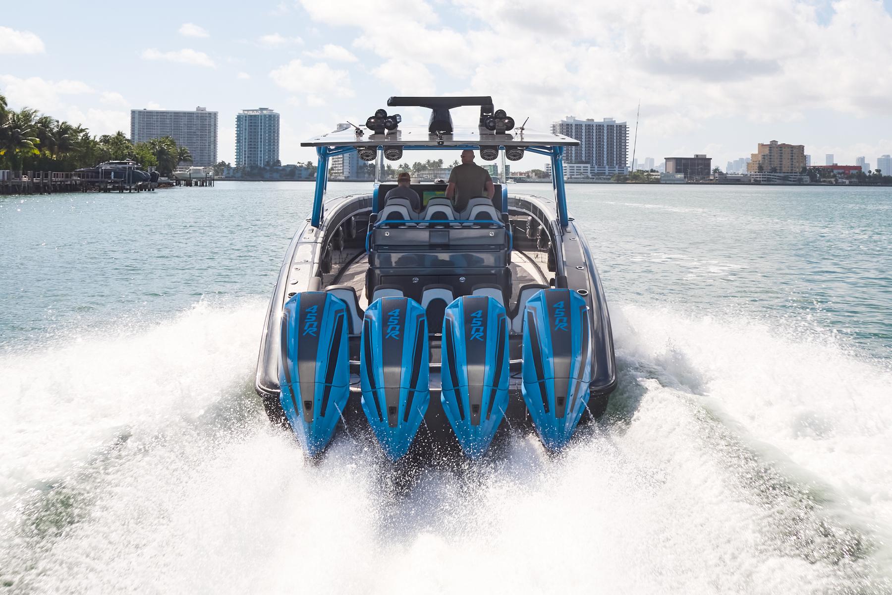 2023 Midnight Express 43' Solstice boat cruising with four powerful engines on a sunny day.