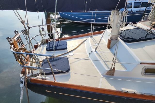 1984 Bristol 45.5 Center Cockpit sailboat with cushioned seating and polished deck.