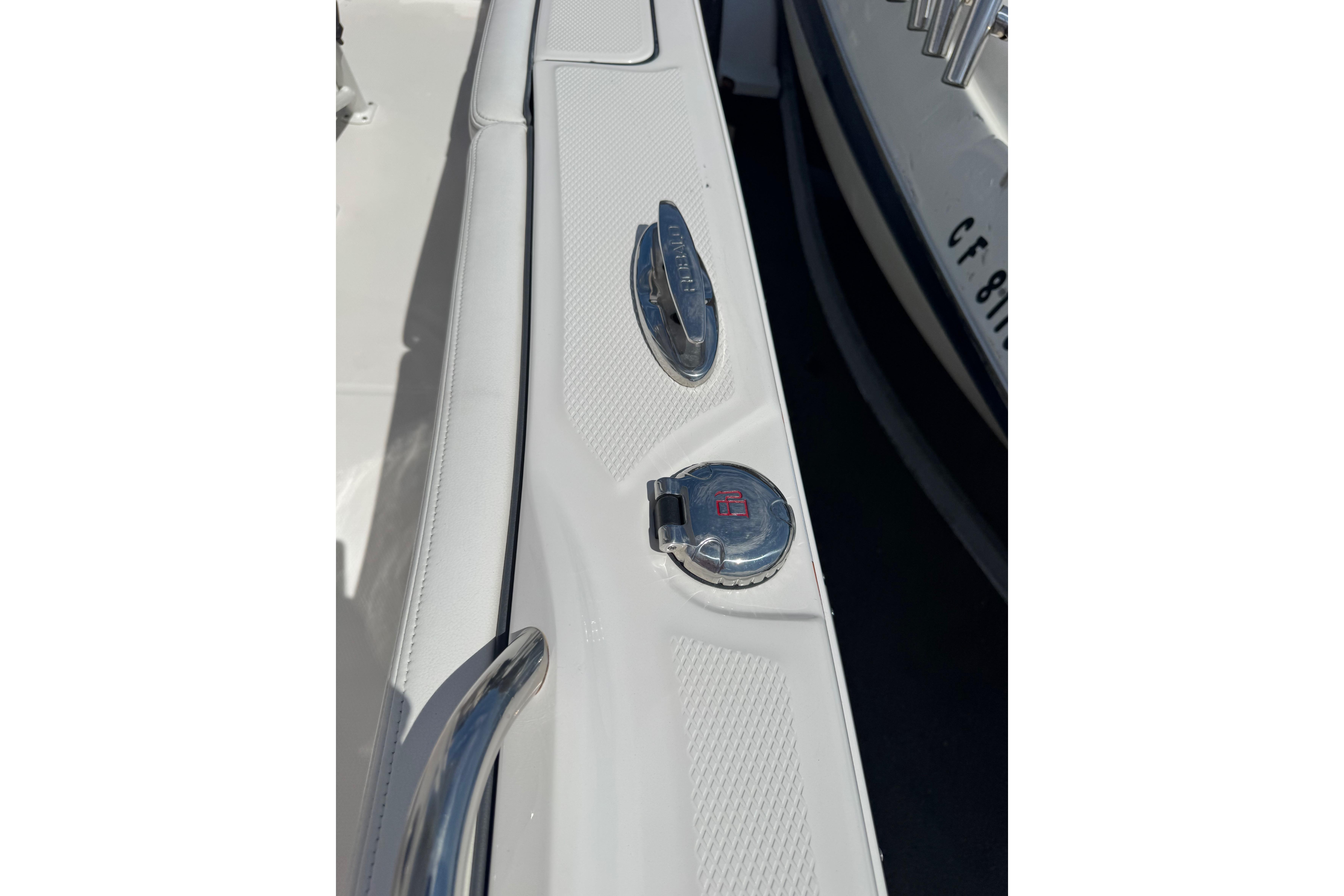 2022 Robalo R230 Center Console boat deck with chrome fittings and textured surface.