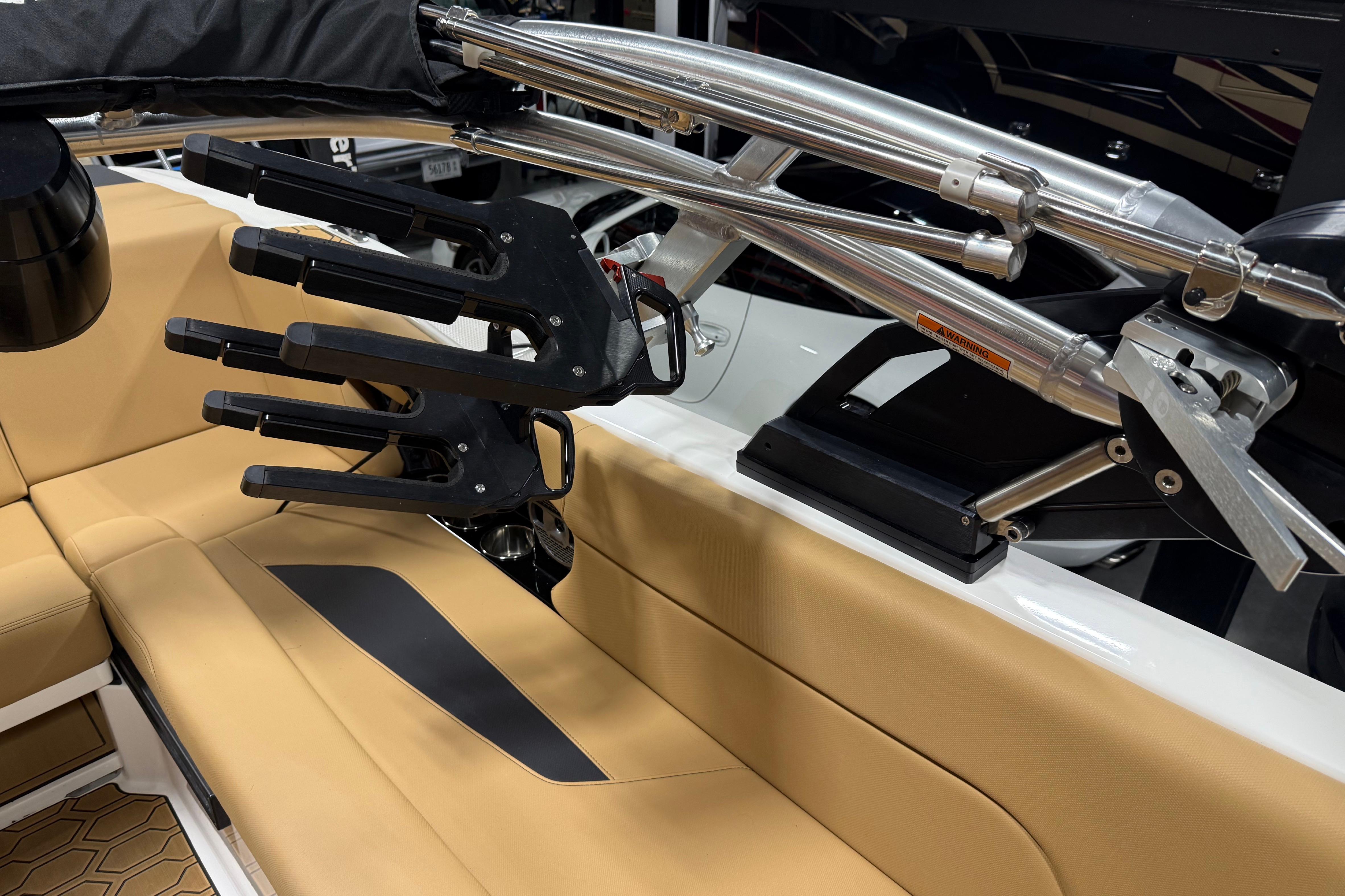 2022 MasterCraft NXT24 boat interior with tan seating and wakeboard rack.