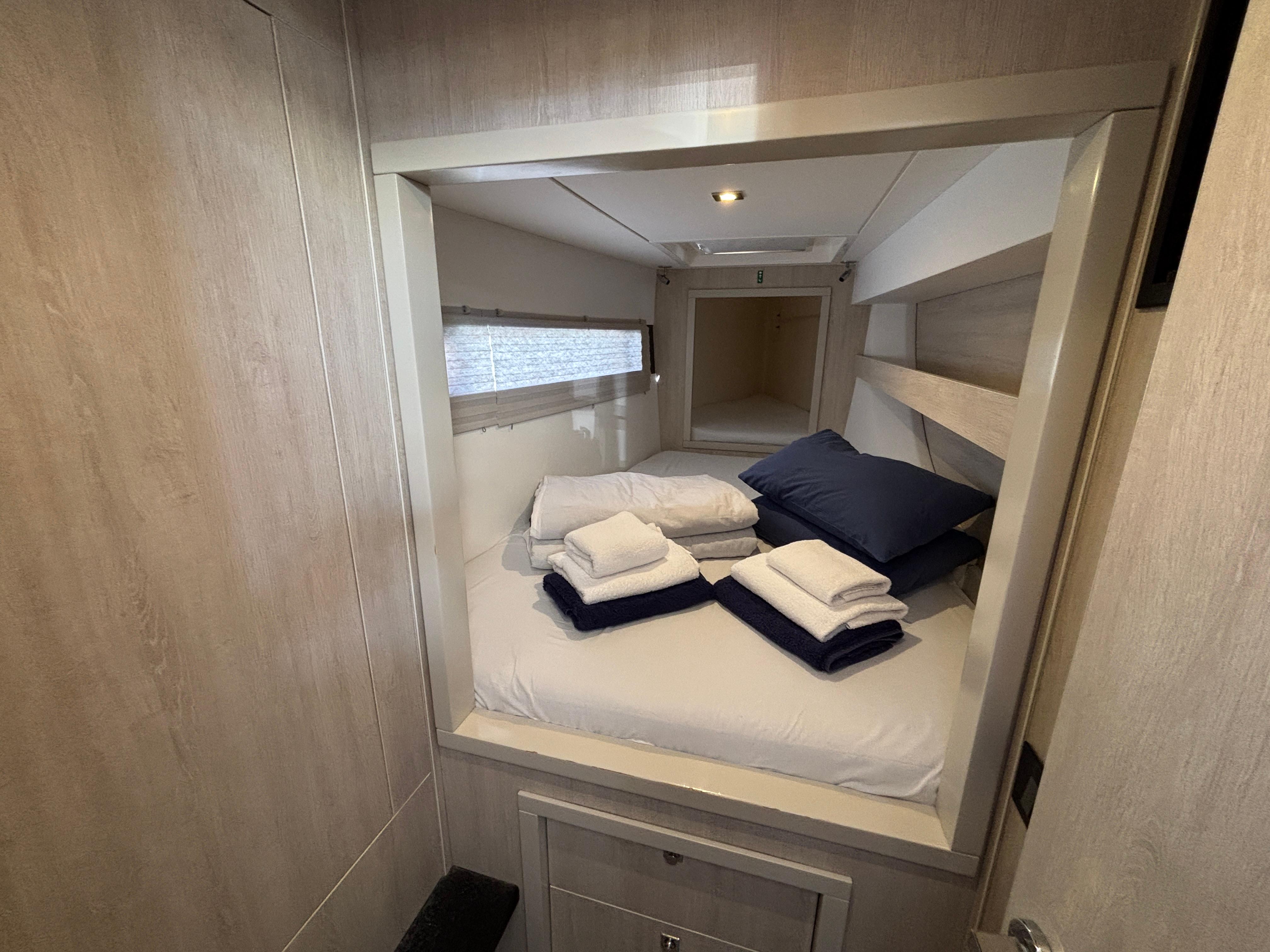 Cozy cabin interior of 2019 Leopard 40 yacht with neatly arranged bedding.