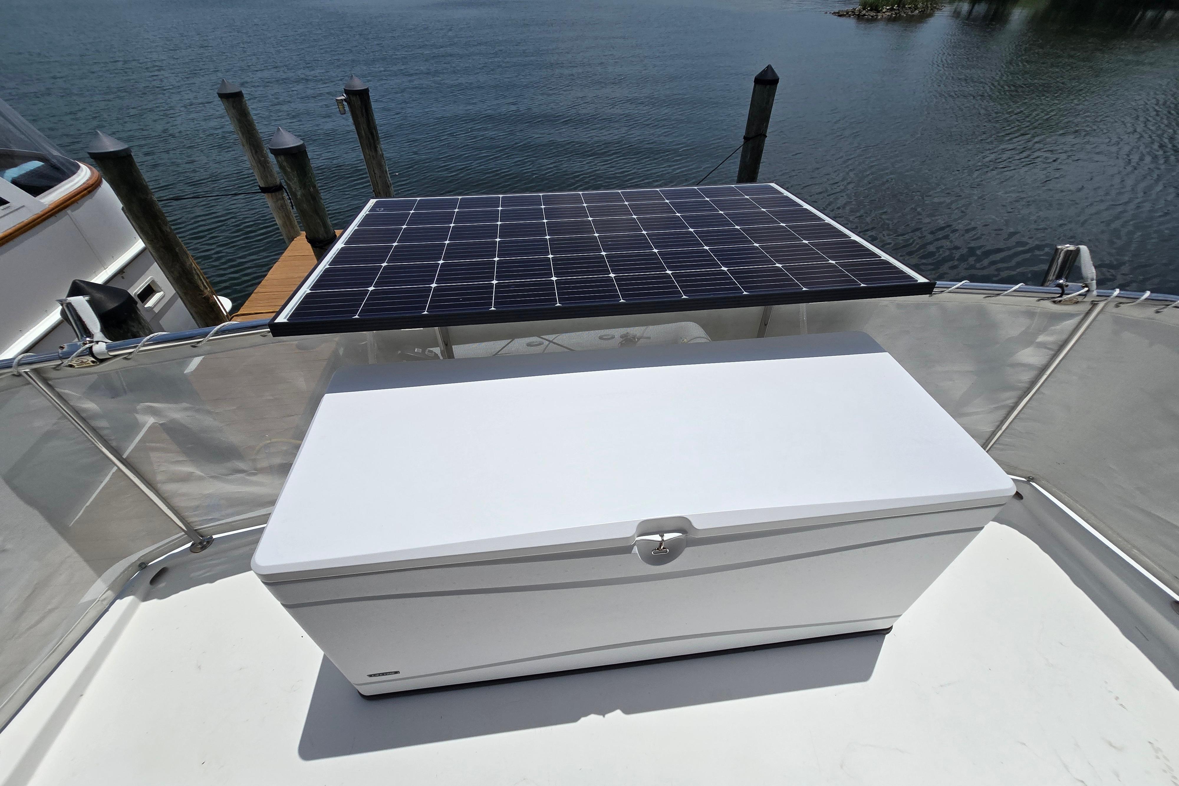 Solar panel and storage box on 2004 Grand Harbour 58 yacht deck by the water.