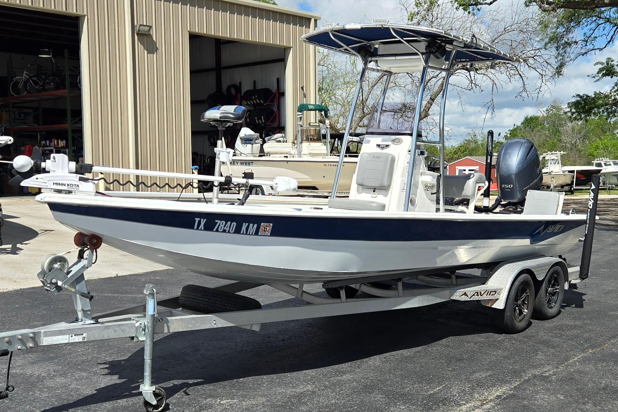 2021 Avid 23 FS boat on trailer, parked outside a storage facility.