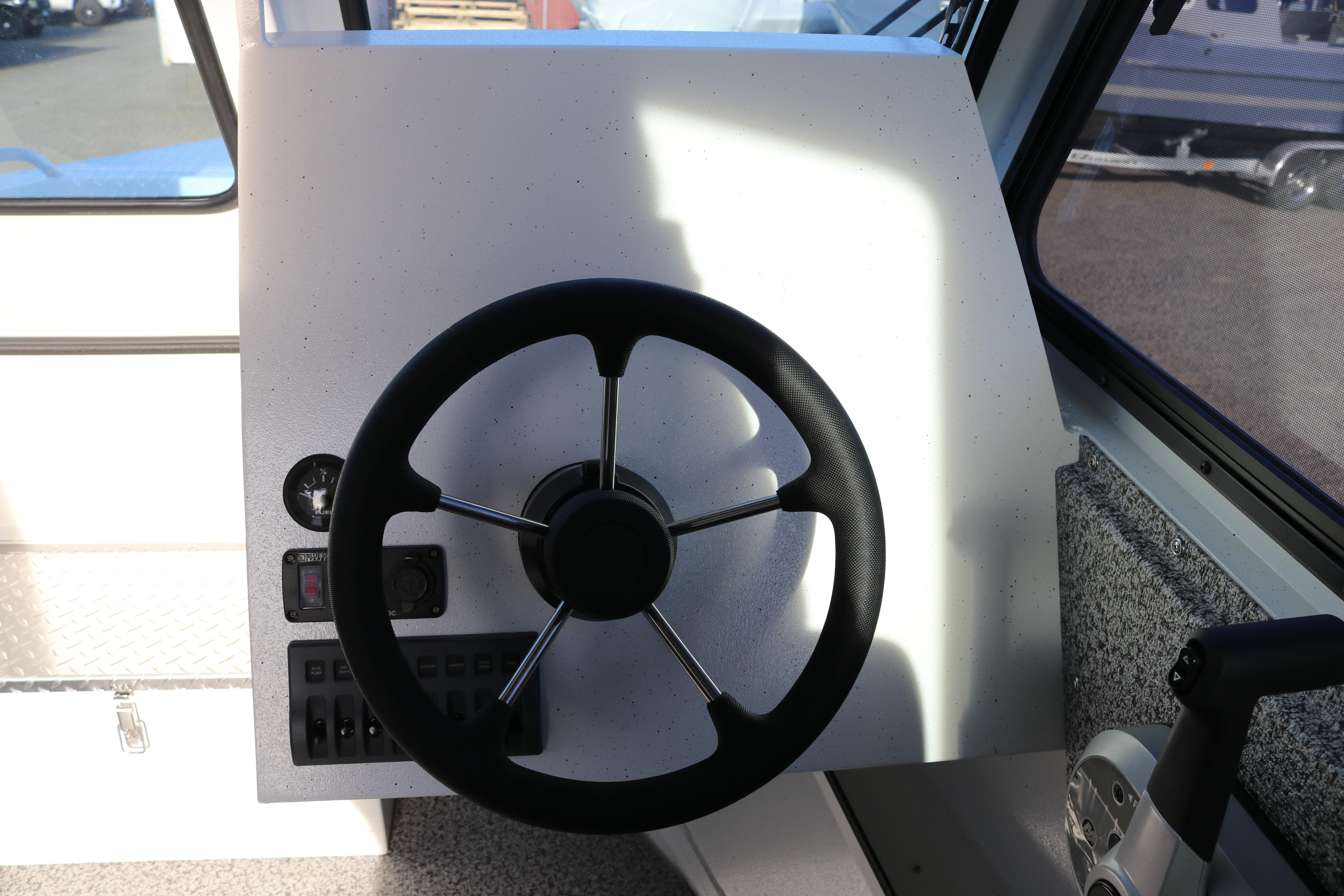 Steering wheel and controls of 2026 Alumaweld Intruder Outboard 22 boat.
