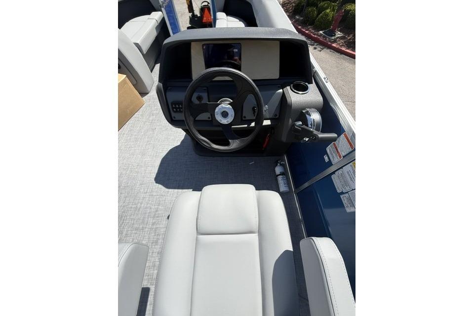 2026 Sun Tracker Party Barge 18 DLX interior with steering wheel and seating.