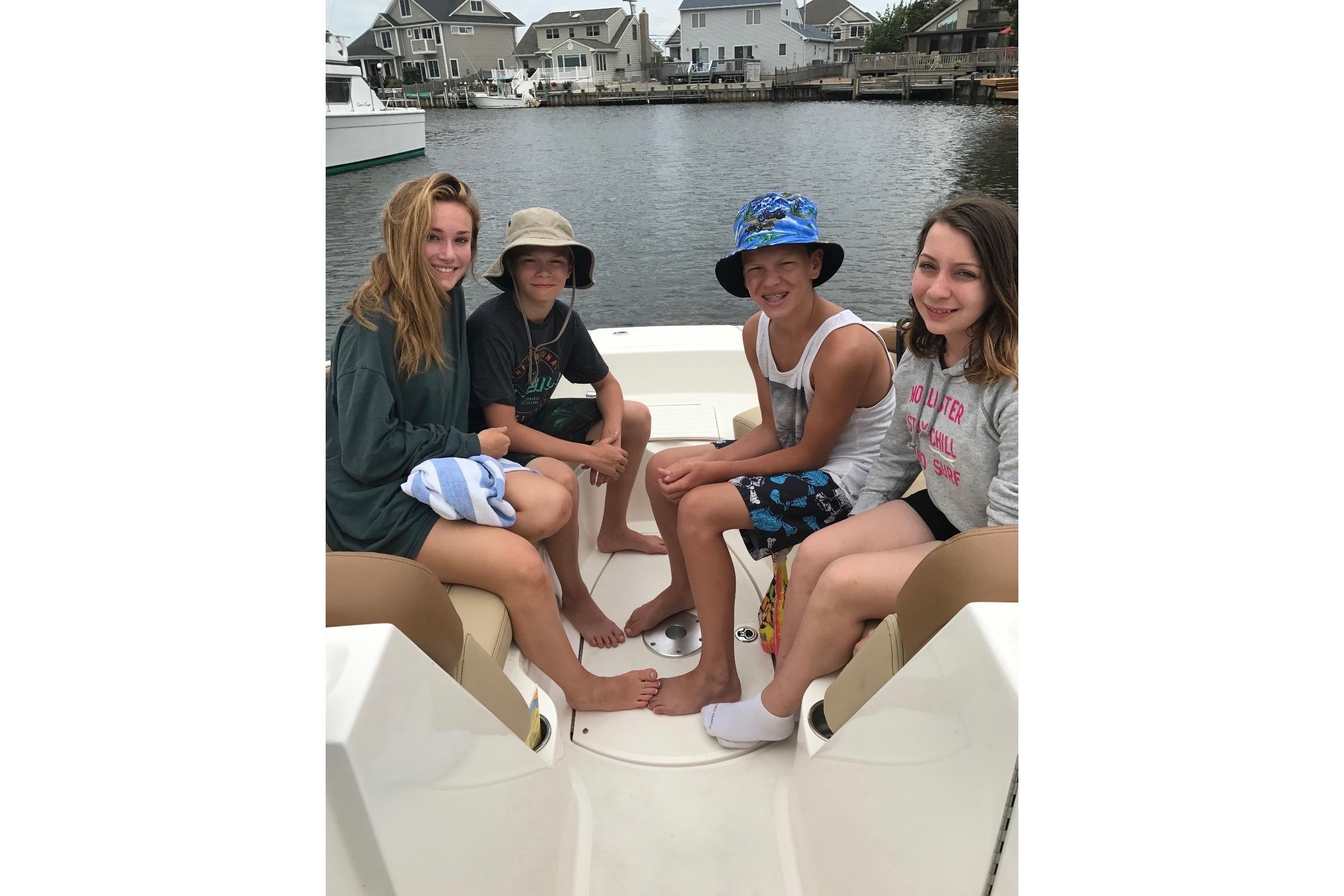 Group of kids enjoying a day on a 2014 Sea Ray 260 Sundeck boat.