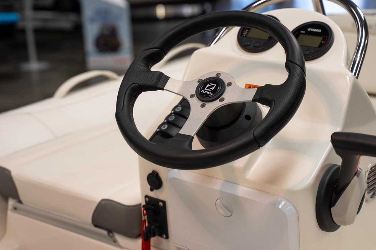 Steering wheel of 2026 Zodiac Yachtline 360 boat, featuring modern controls and dashboard.