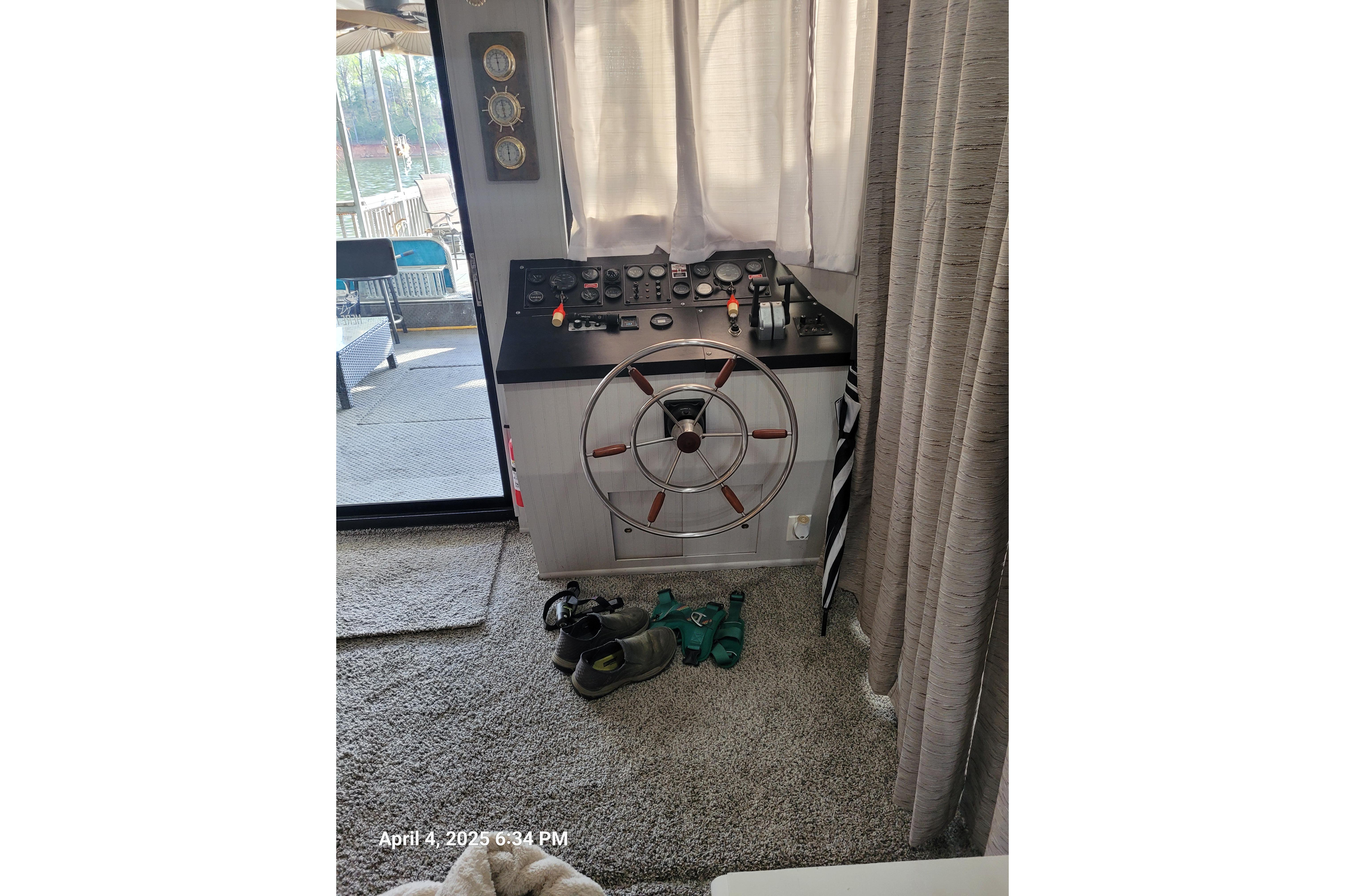 Interior helm of a 1990 Sumerset 16 x 70 houseboat with steering wheel and controls.