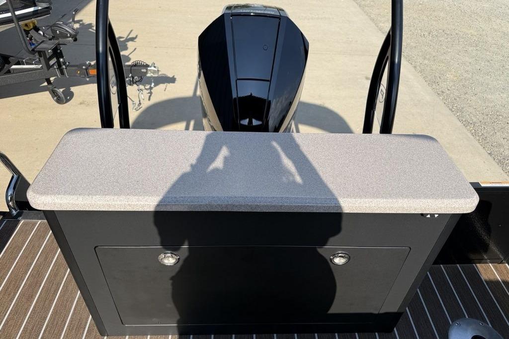 2026 Premier 250 Solaris RS CL boat with sleek black motor and storage compartment.