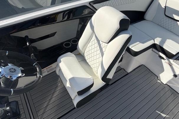 2026 Yamaha Boats 222S interior with white seating and sleek steering wheel design.