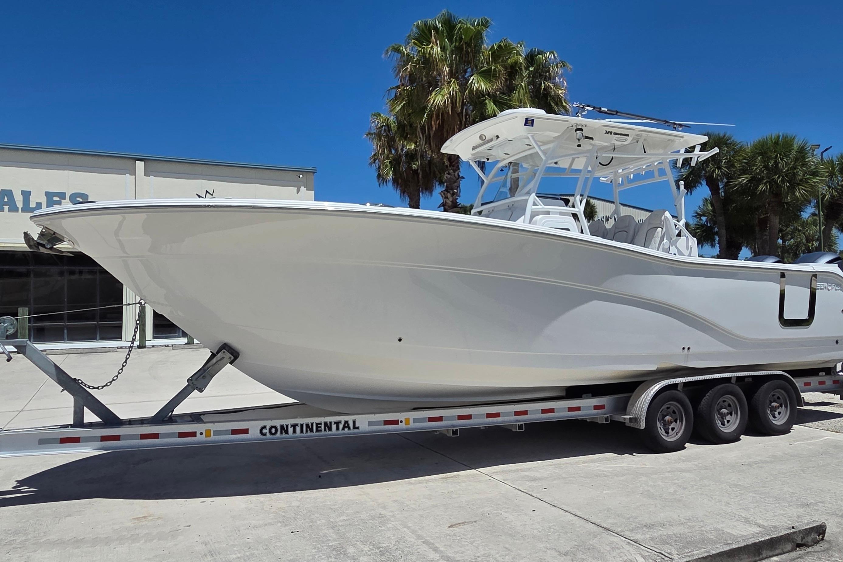 2021 Sea Fox 328 Commander boat on trailer under clear blue sky.