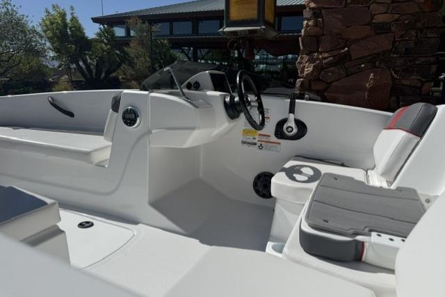 2026 Tahoe T16 boat interior with steering wheel and seating, showcasing modern design.