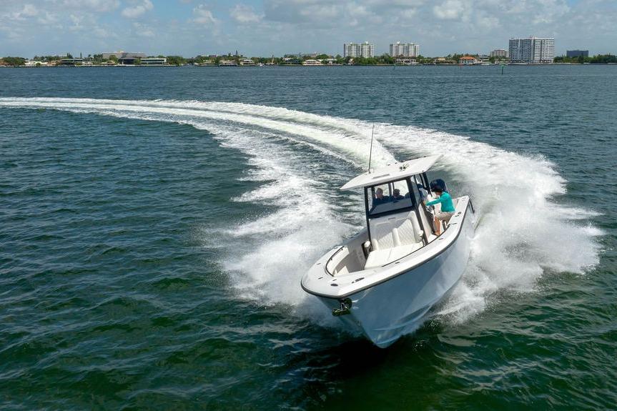 2027 Reef Runner 340 boat cruising on open water, creating a dynamic wake.