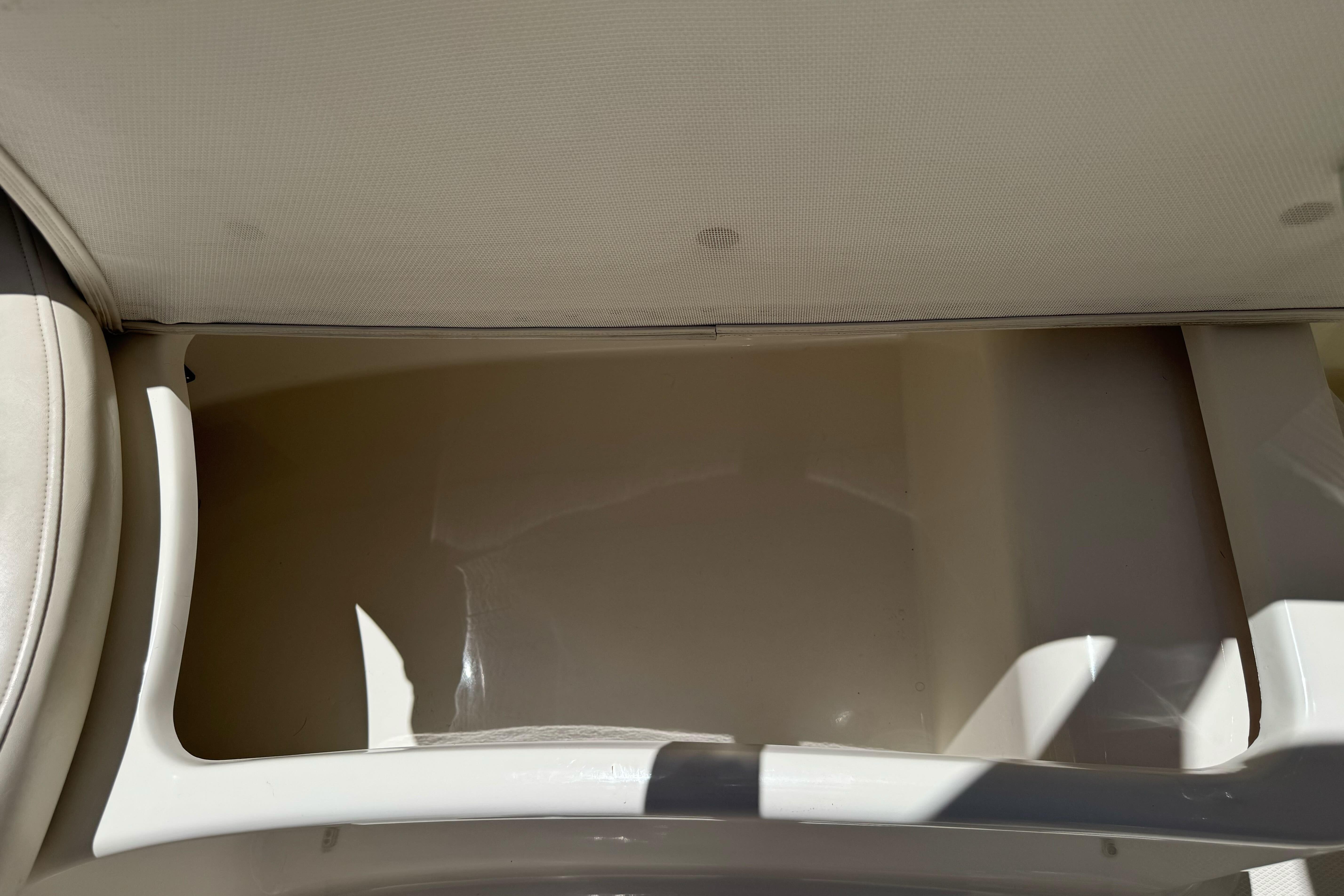 Storage compartment in a 2007 Sea Ray SLX 250 boat, featuring clean interior space.