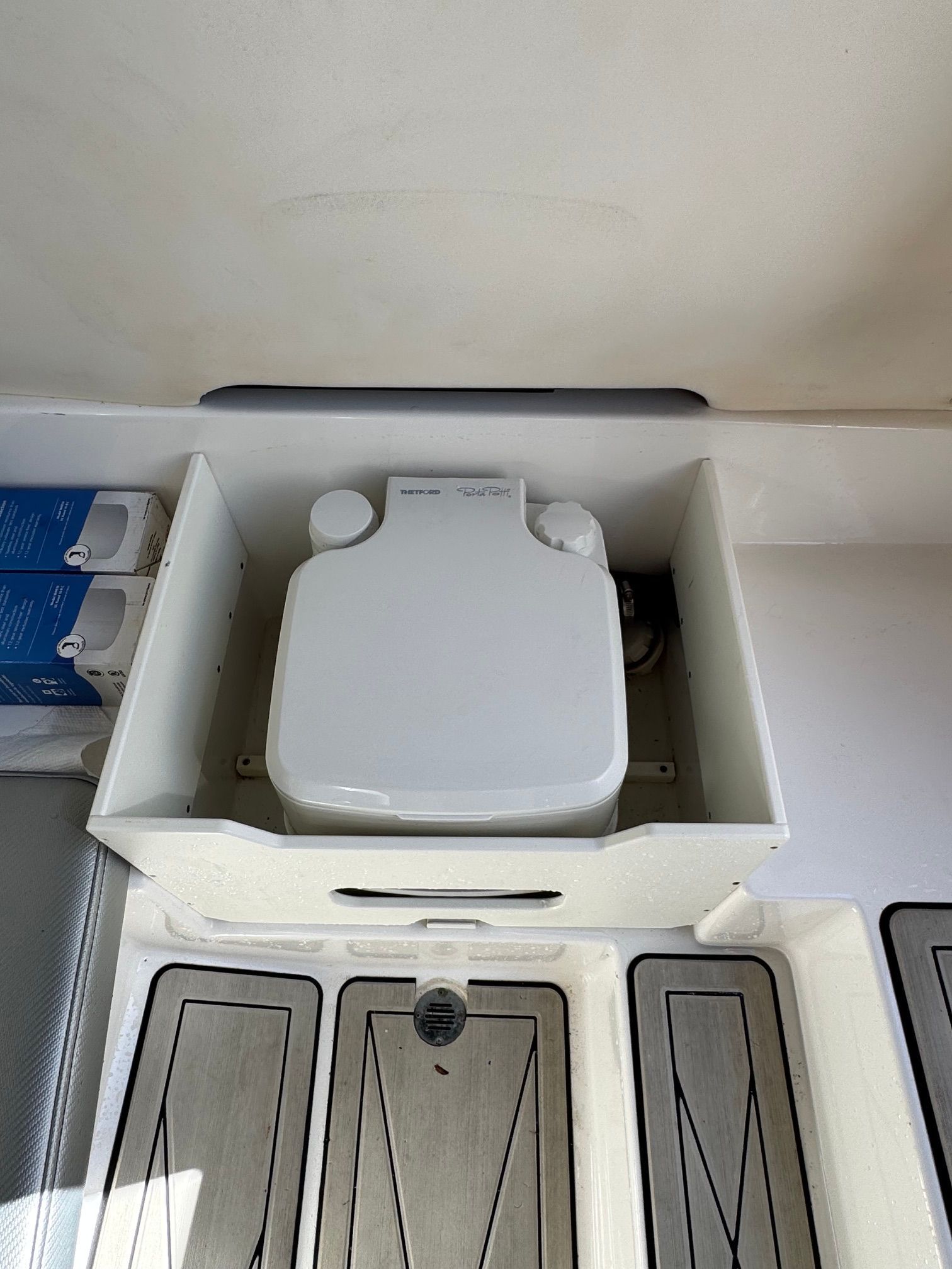 2017 Sunsation 32 CCX boat toilet with storage compartment.