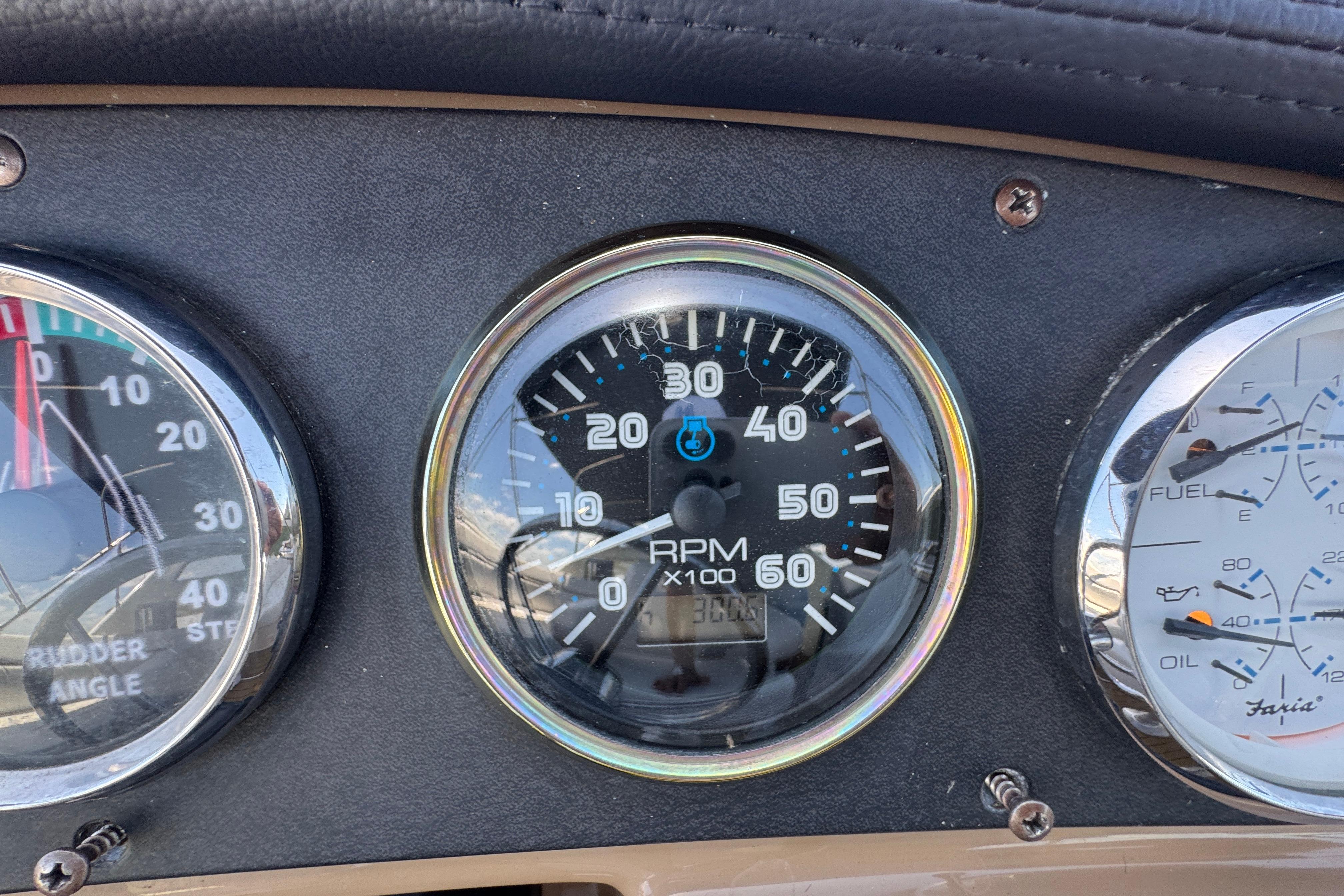 Dashboard gauges of a 2002 Carver 396 Motor Yacht, showing RPM and rudder angle.