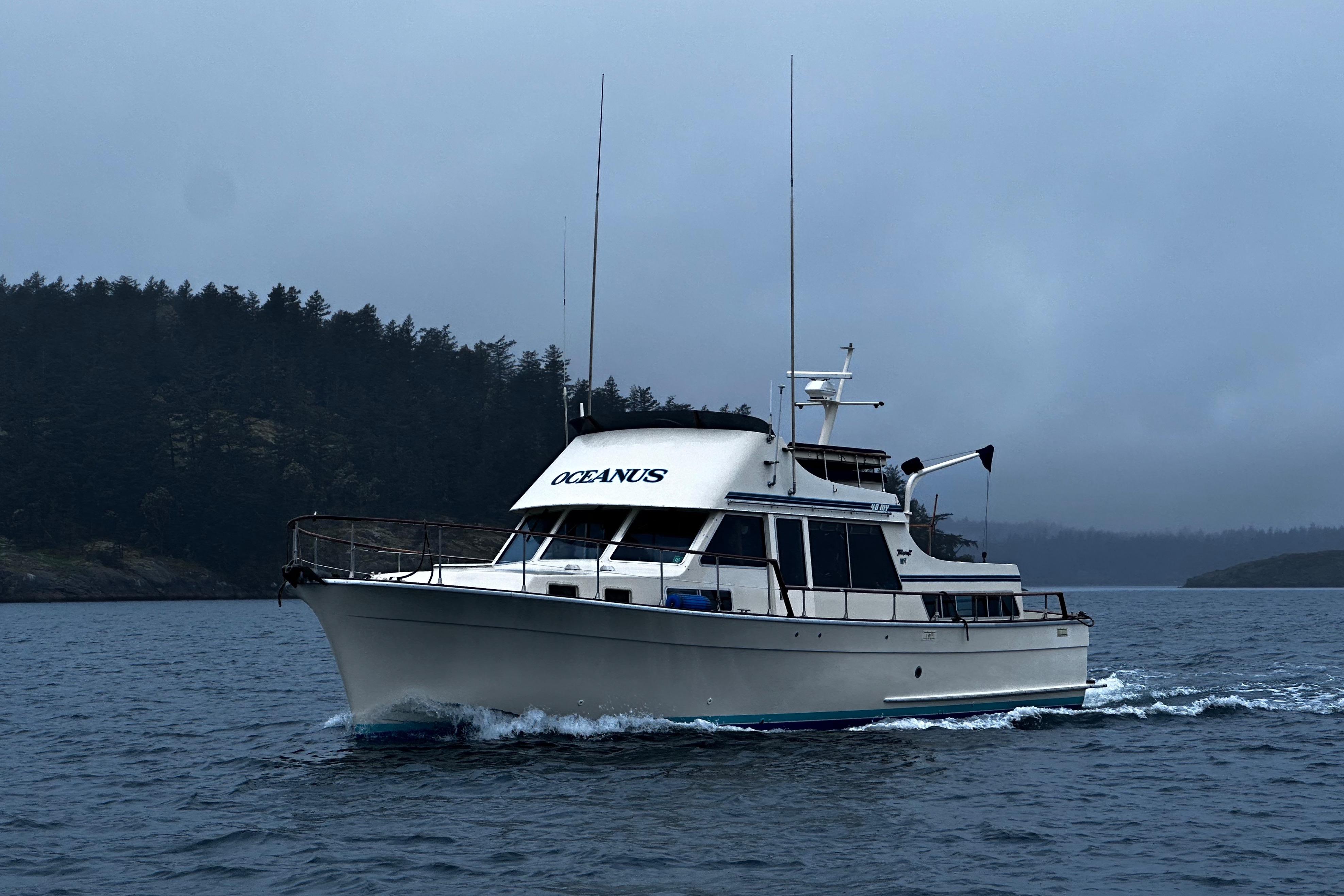 1981 Tollycraft 48 Motor Yacht cruising on a misty lake.