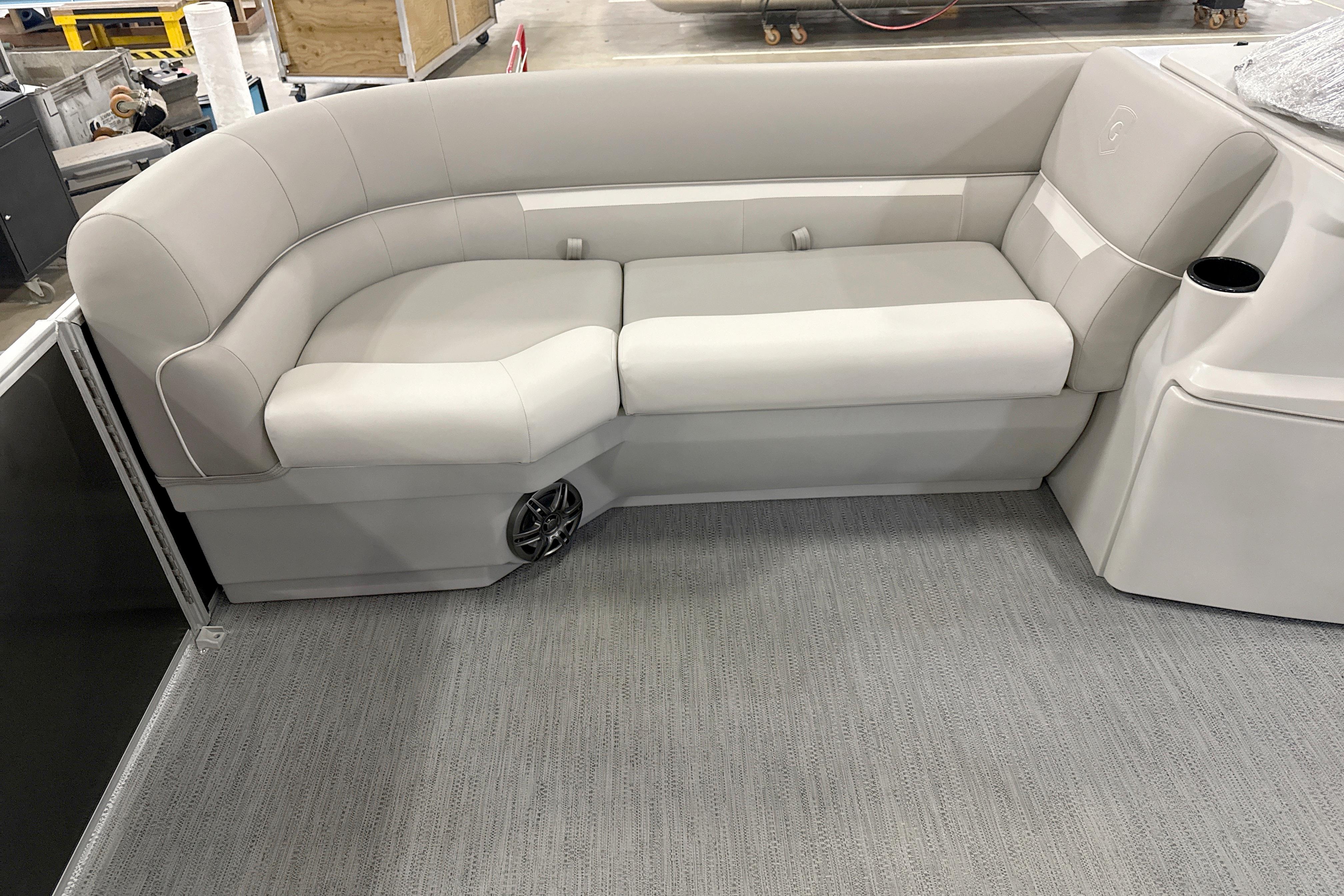 Luxurious seating on 2026 Godfrey EX 2286 SBX pontoon boat, featuring plush upholstery and integrated speaker.