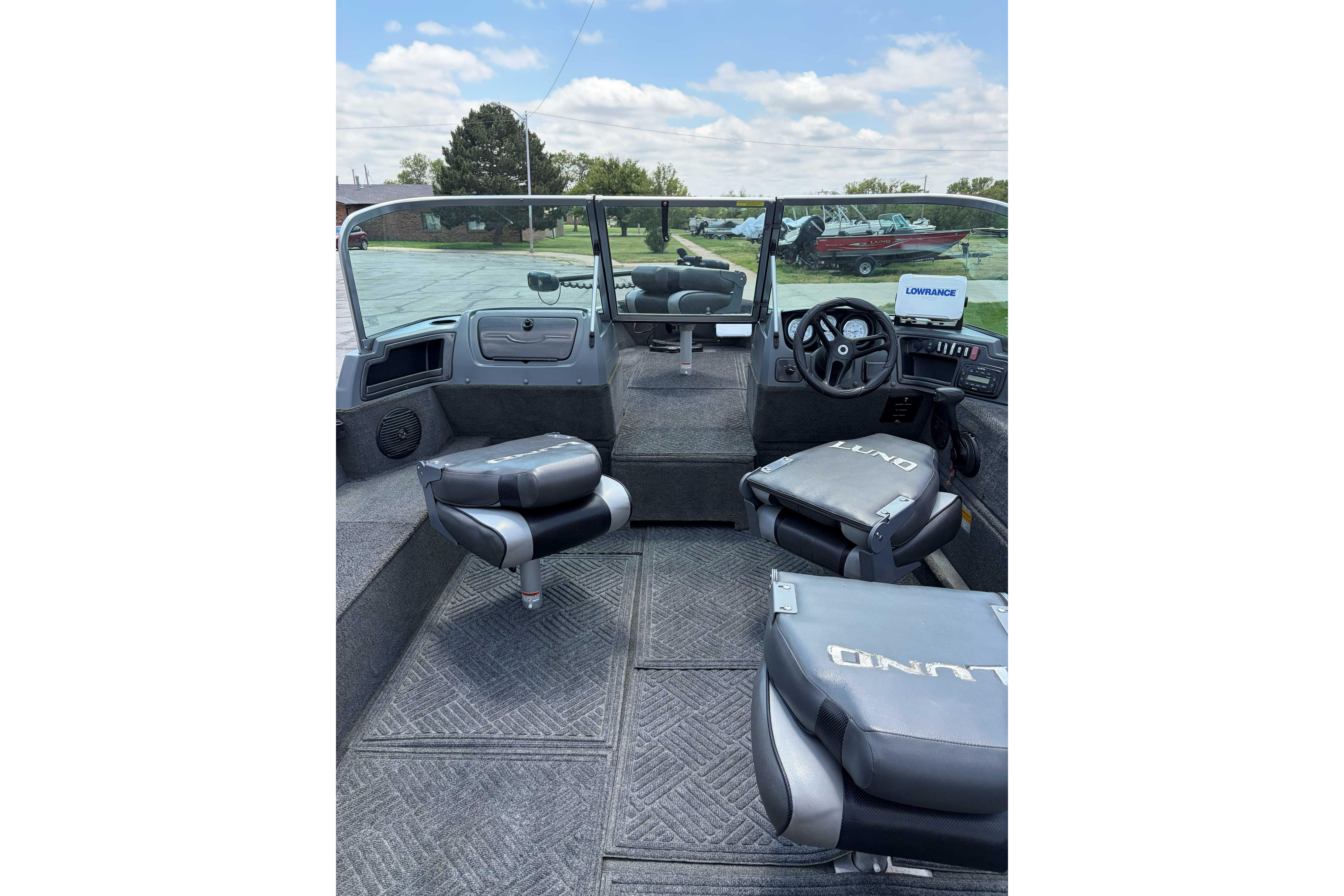 2014 Lund 1875 Impact XS boat interior with seating and steering console.