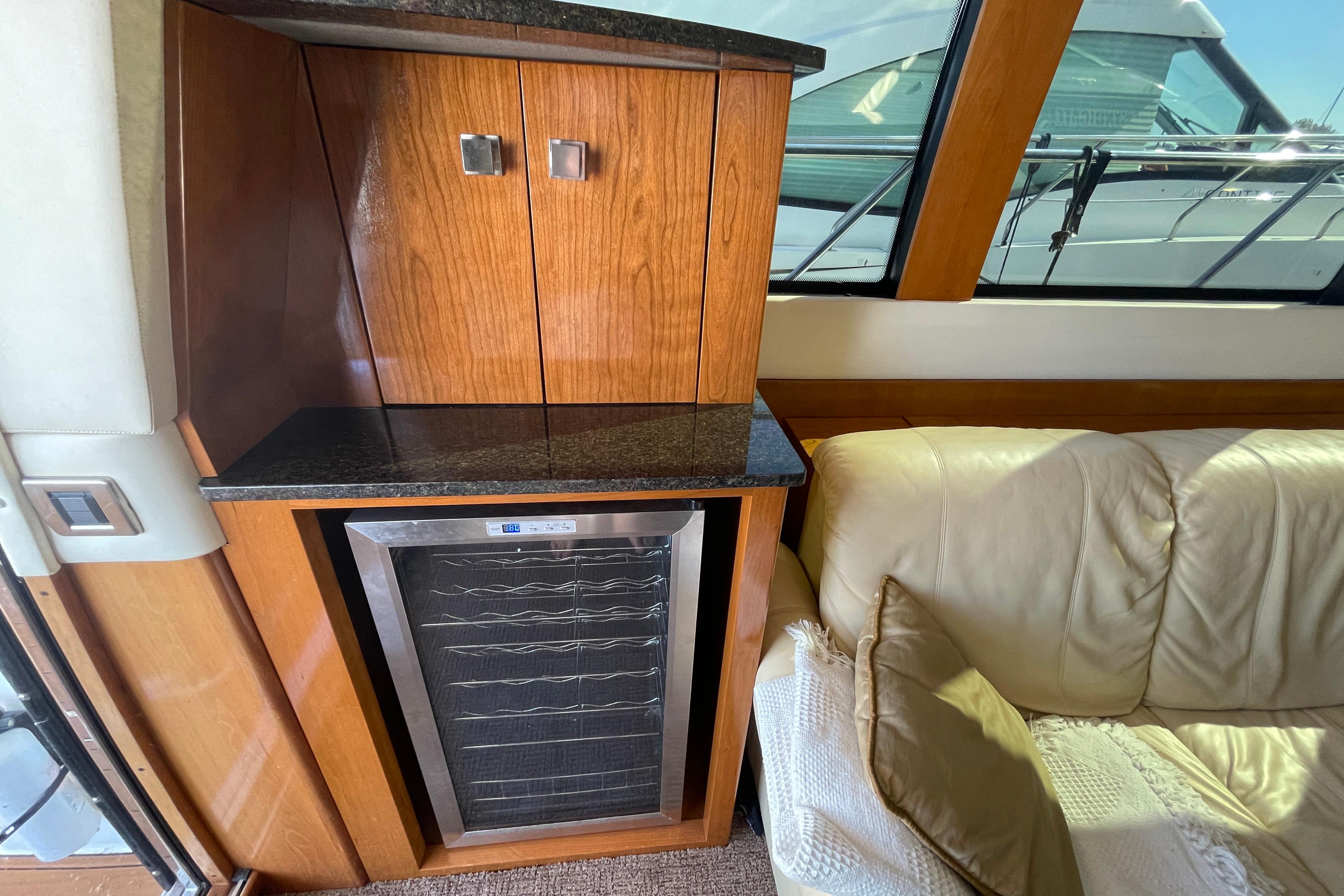 Interior of 2002 Carver 570 Voyager Pilothouse with wooden cabinetry and leather seating.