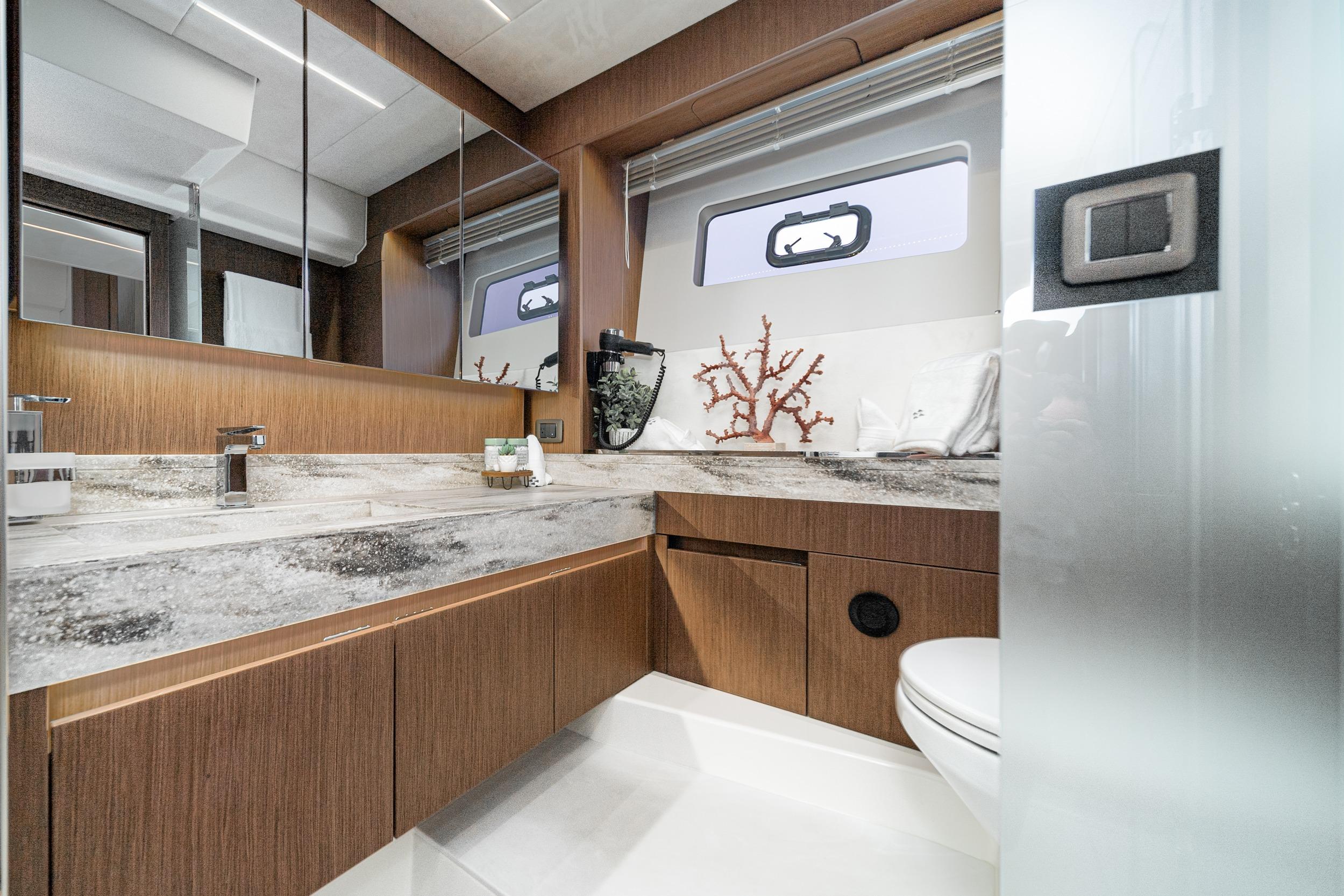 Luxurious bathroom in 2024 Prestige X60 yacht with modern fixtures and elegant design.