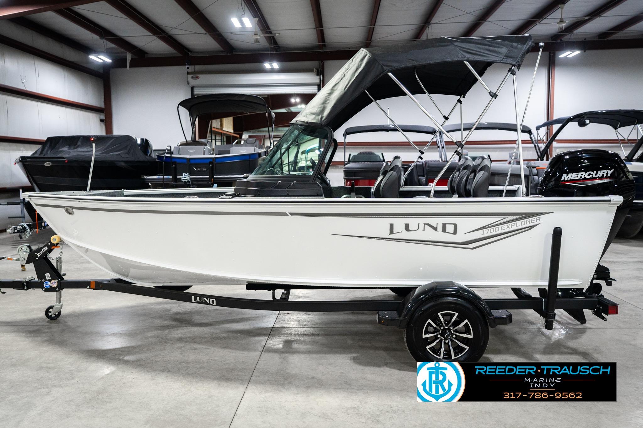 2026 Lund 1700 Explorer Sport boat in showroom with Mercury engine.