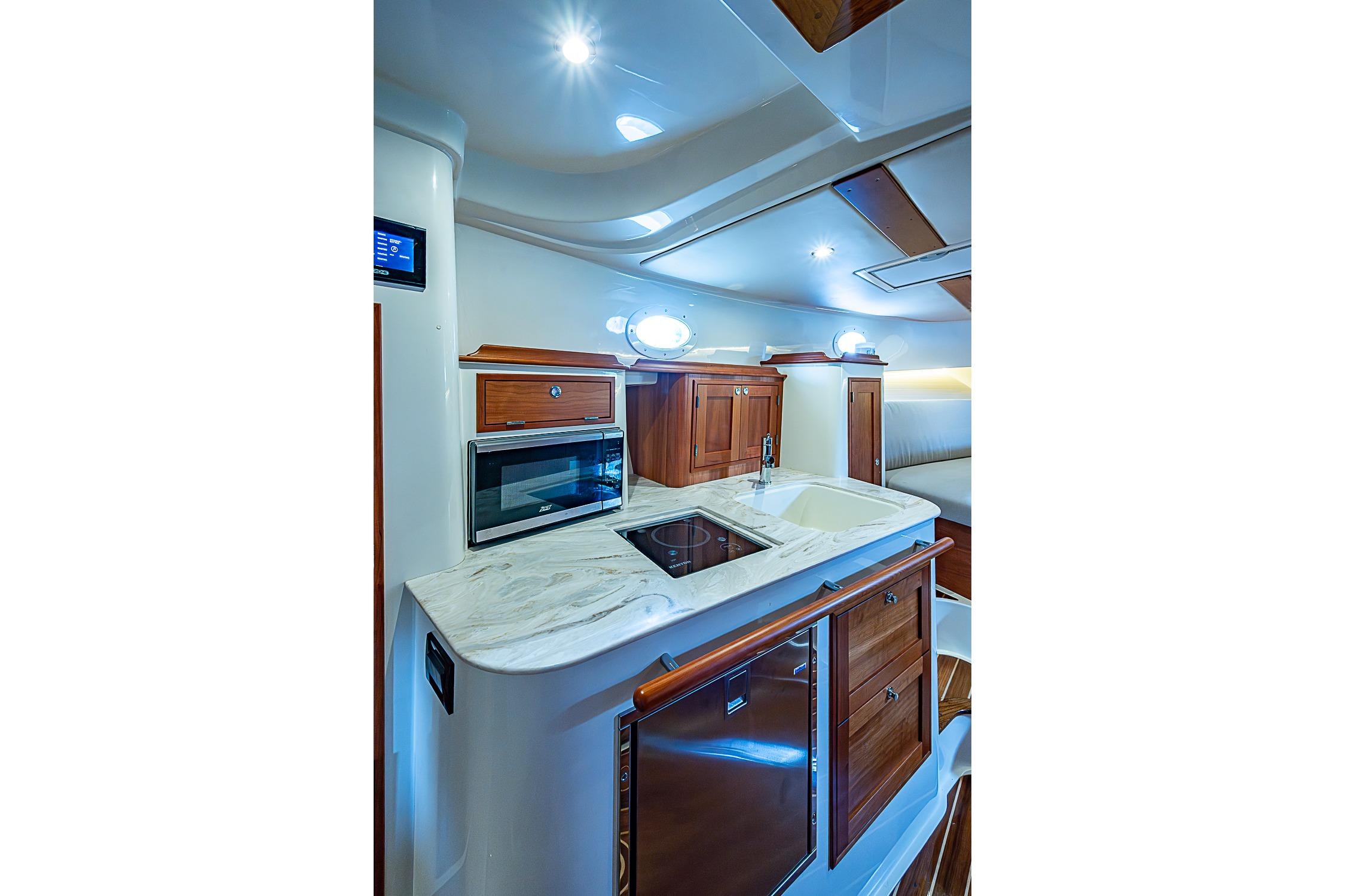 Luxurious interior of 2023 Hinckley Sport Boat 40 X with modern kitchen amenities.