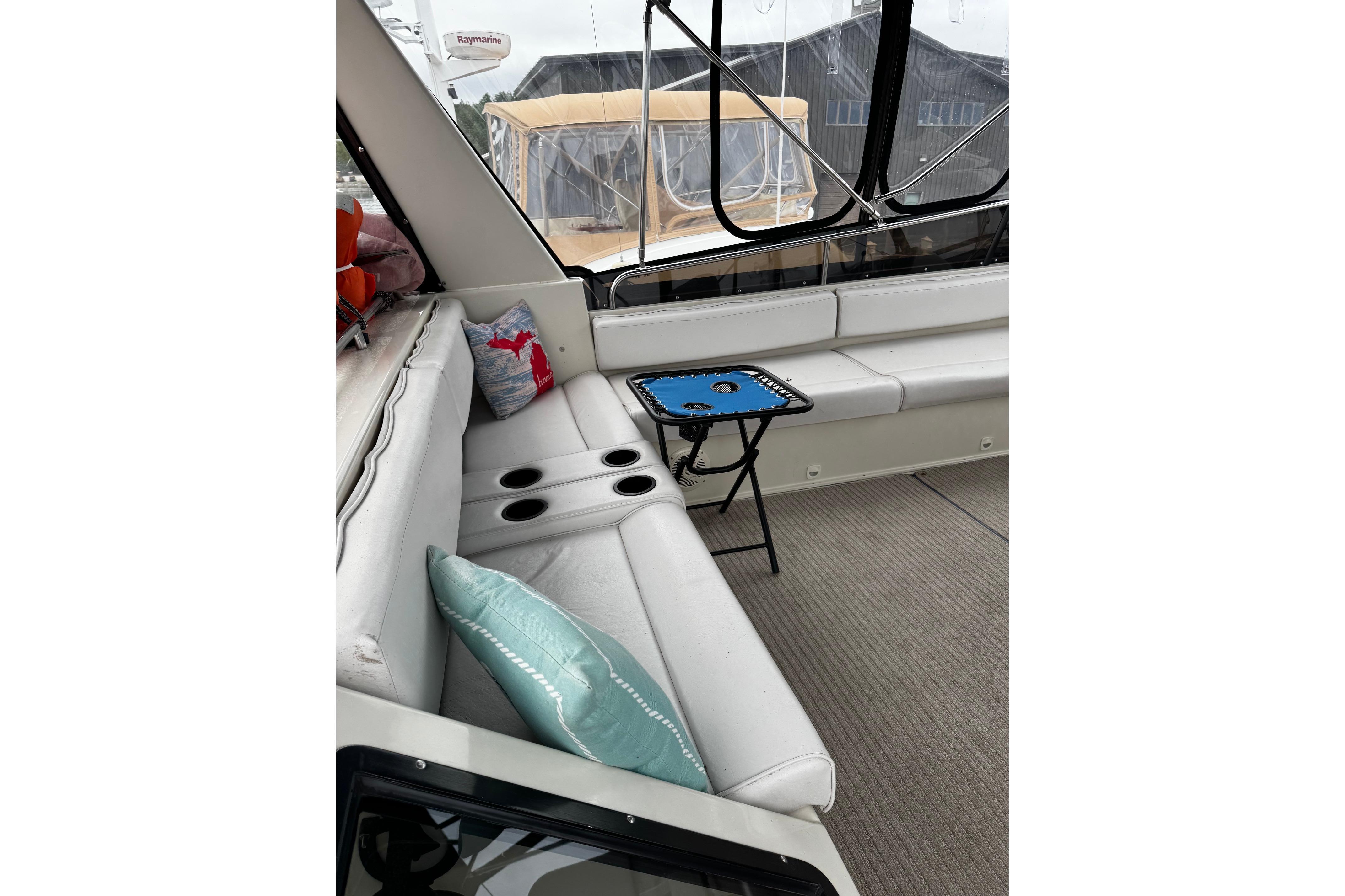 Interior of 1991 Silverton 46 Motor Yacht with white seating and decorative pillows.