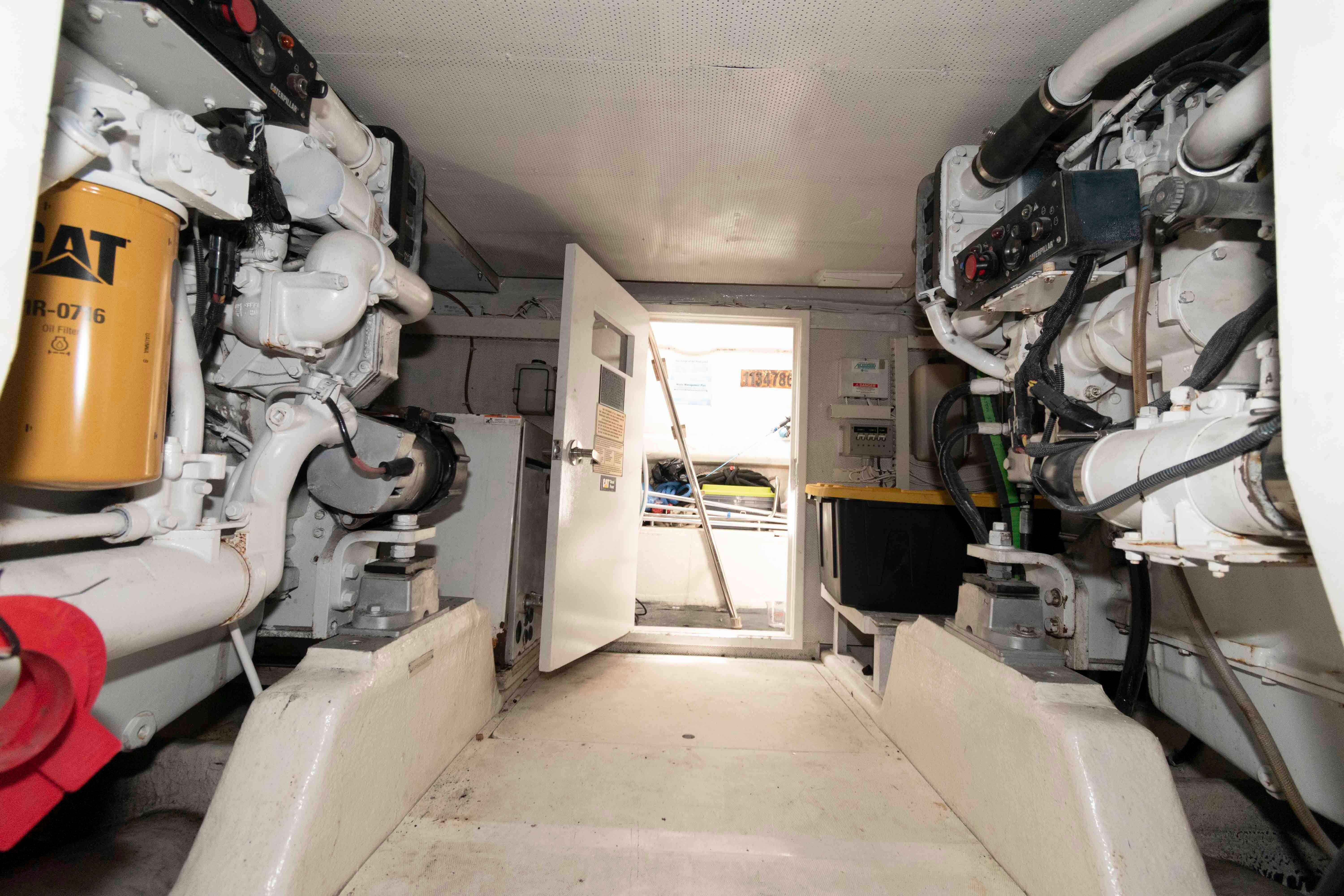 Engine room of a 2003 Neptunus 56 Flybridge yacht, showcasing machinery and equipment.