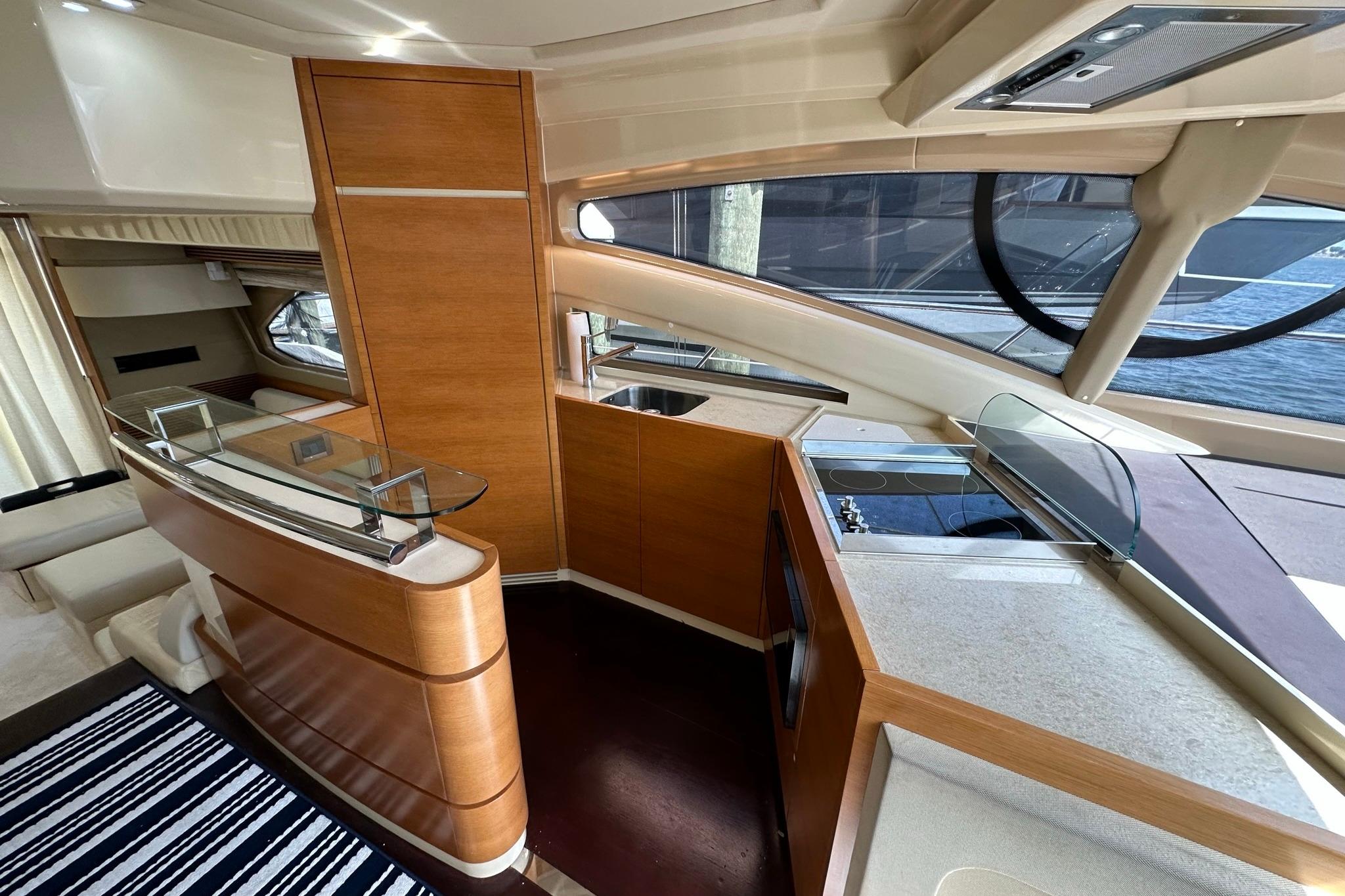 Luxurious interior of 2013 Azimut Fly 53 yacht with modern kitchen and elegant wood finishes.