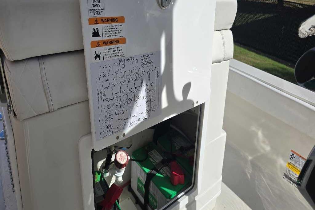 2025 Ranger 2360 Bay boat interior with storage compartment and warning labels.