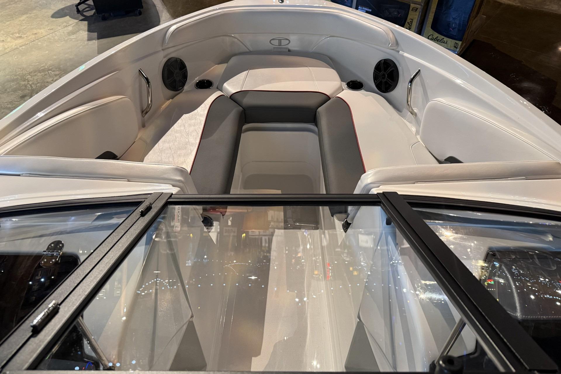 2024 Tahoe 210 S boat interior with cushioned seating and speakers.