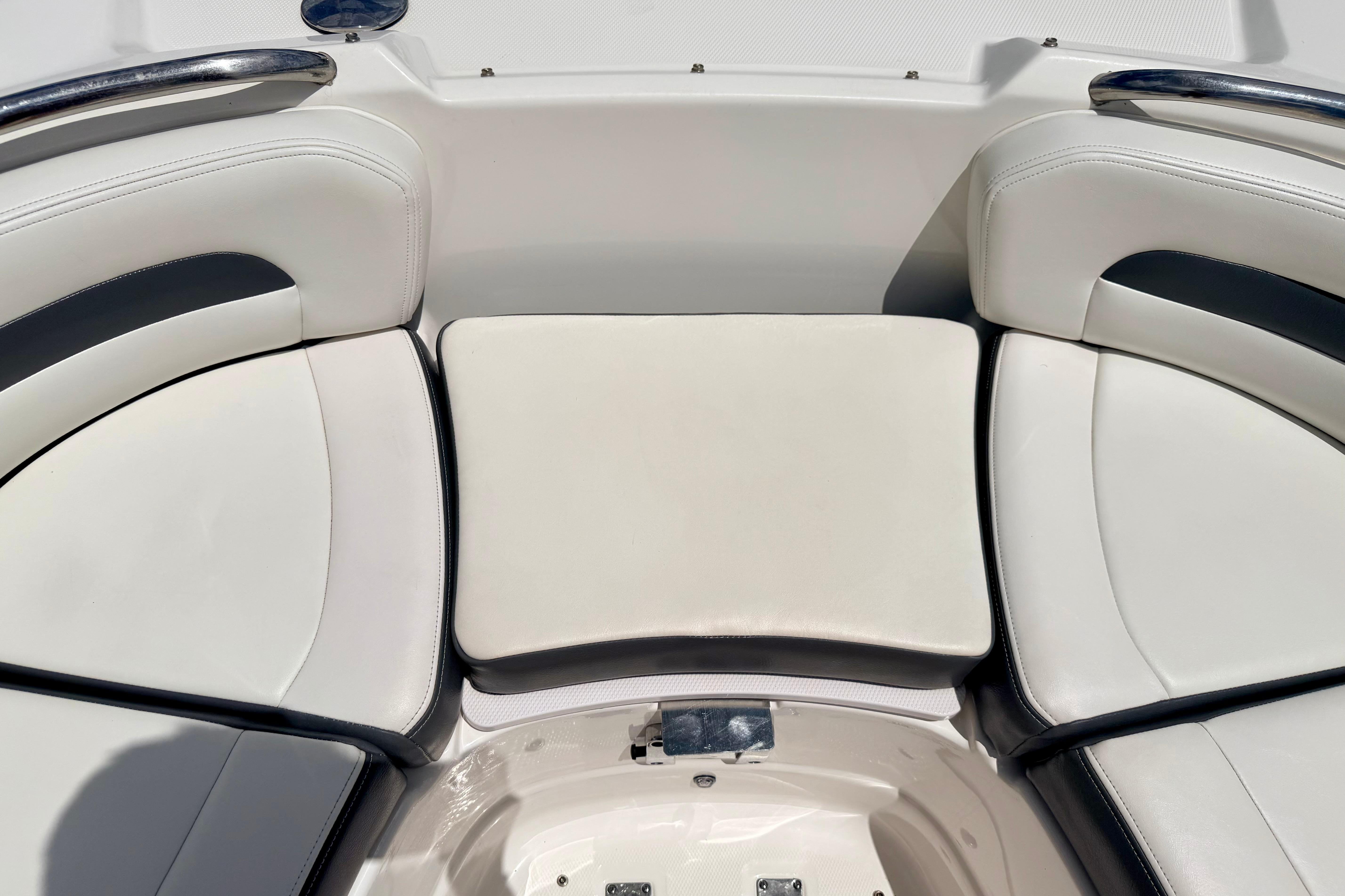 2015 Chaparral Sunesta 264 boat interior with white cushioned seating.
