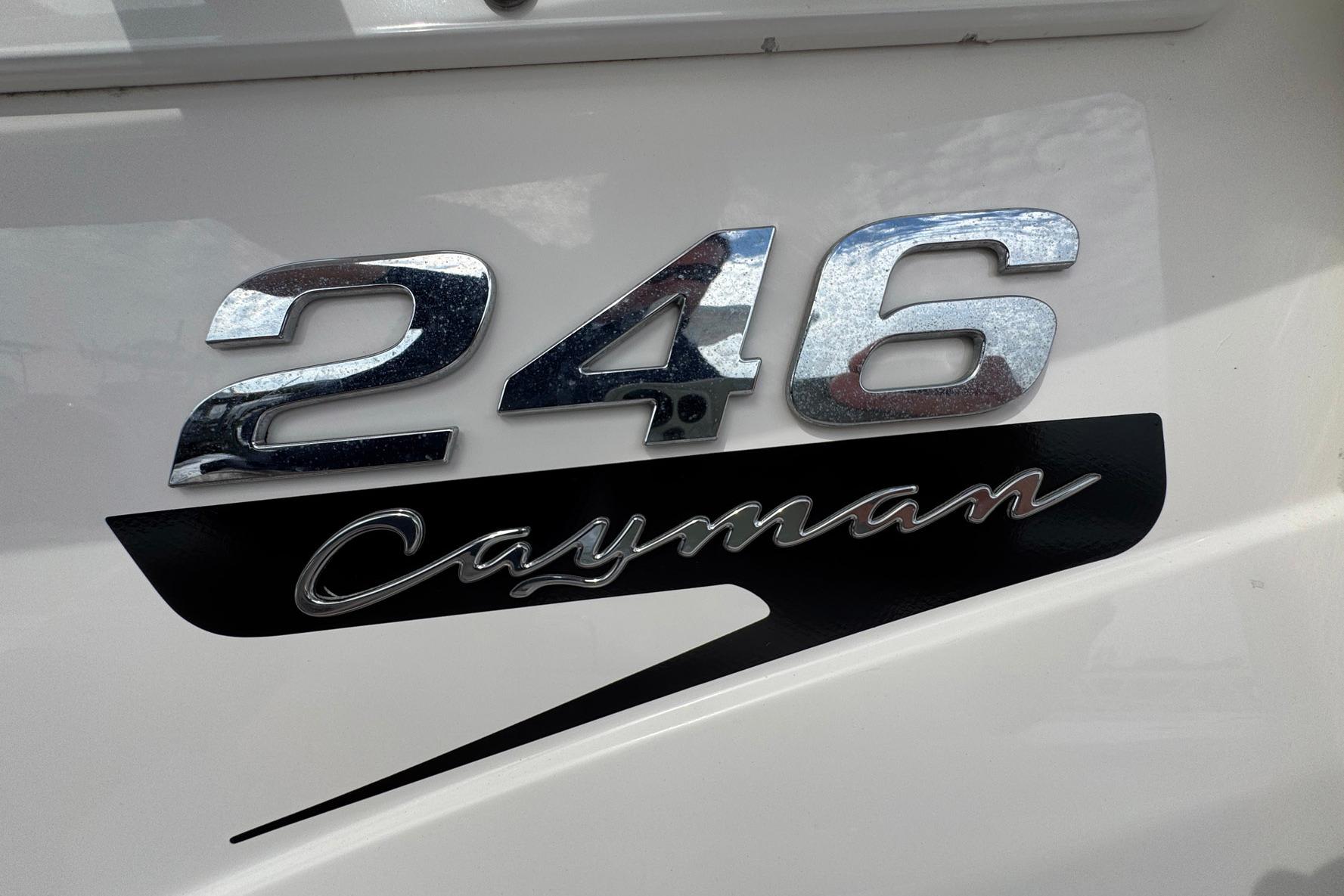2021 Robalo 246 Cayman boat emblem with chrome and black lettering.
