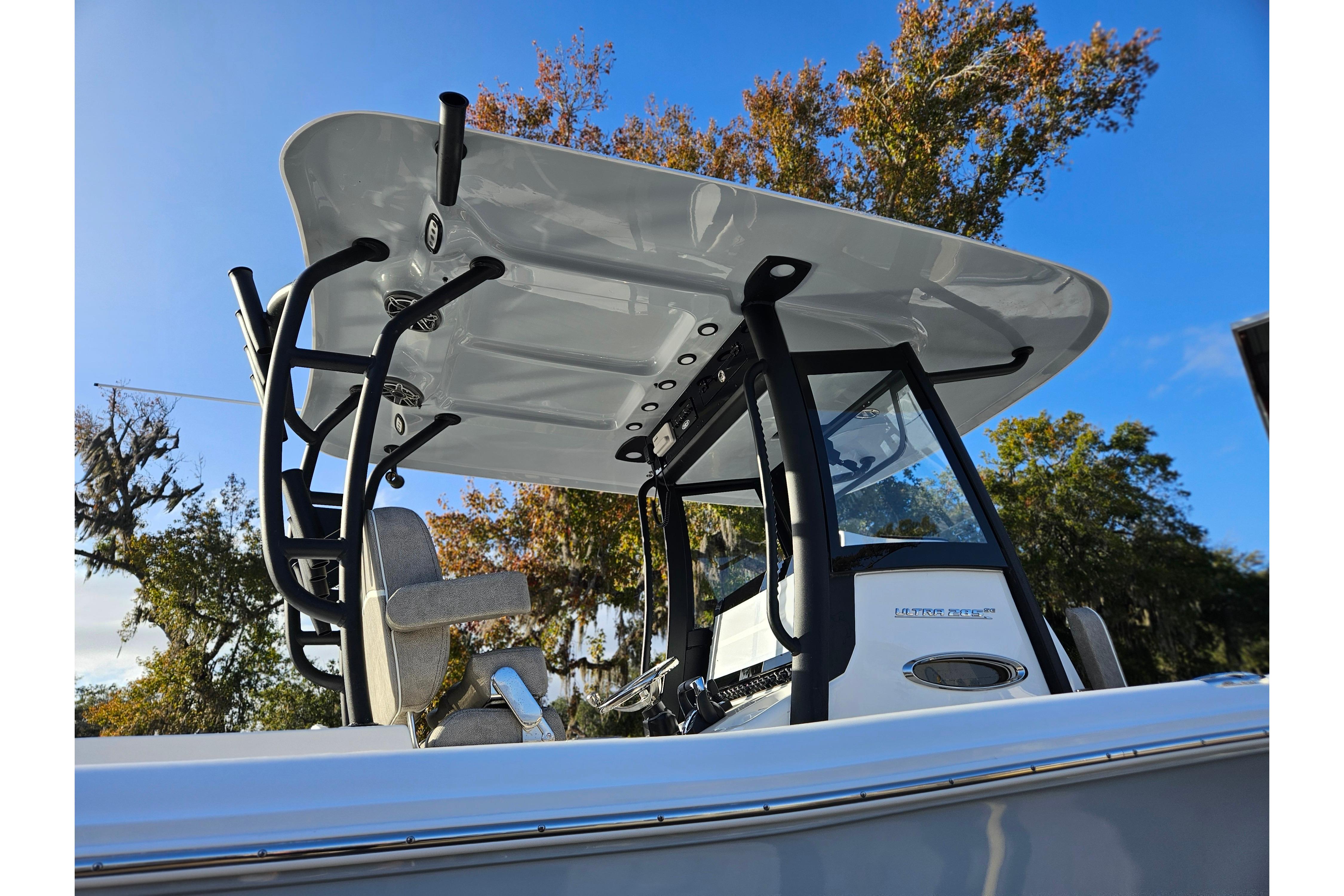 2026 Sea Hunt Ultra 285 SE boat with T-top and console, under clear blue sky.