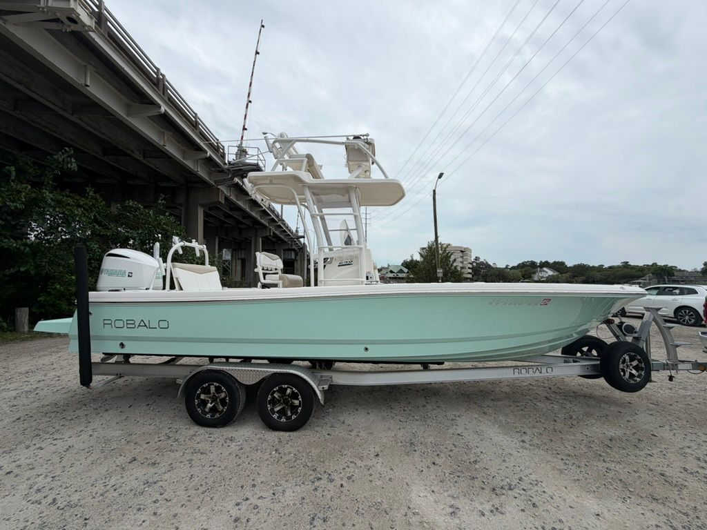 2018 Robalo 246 Cayman SD boat on trailer under bridge.
