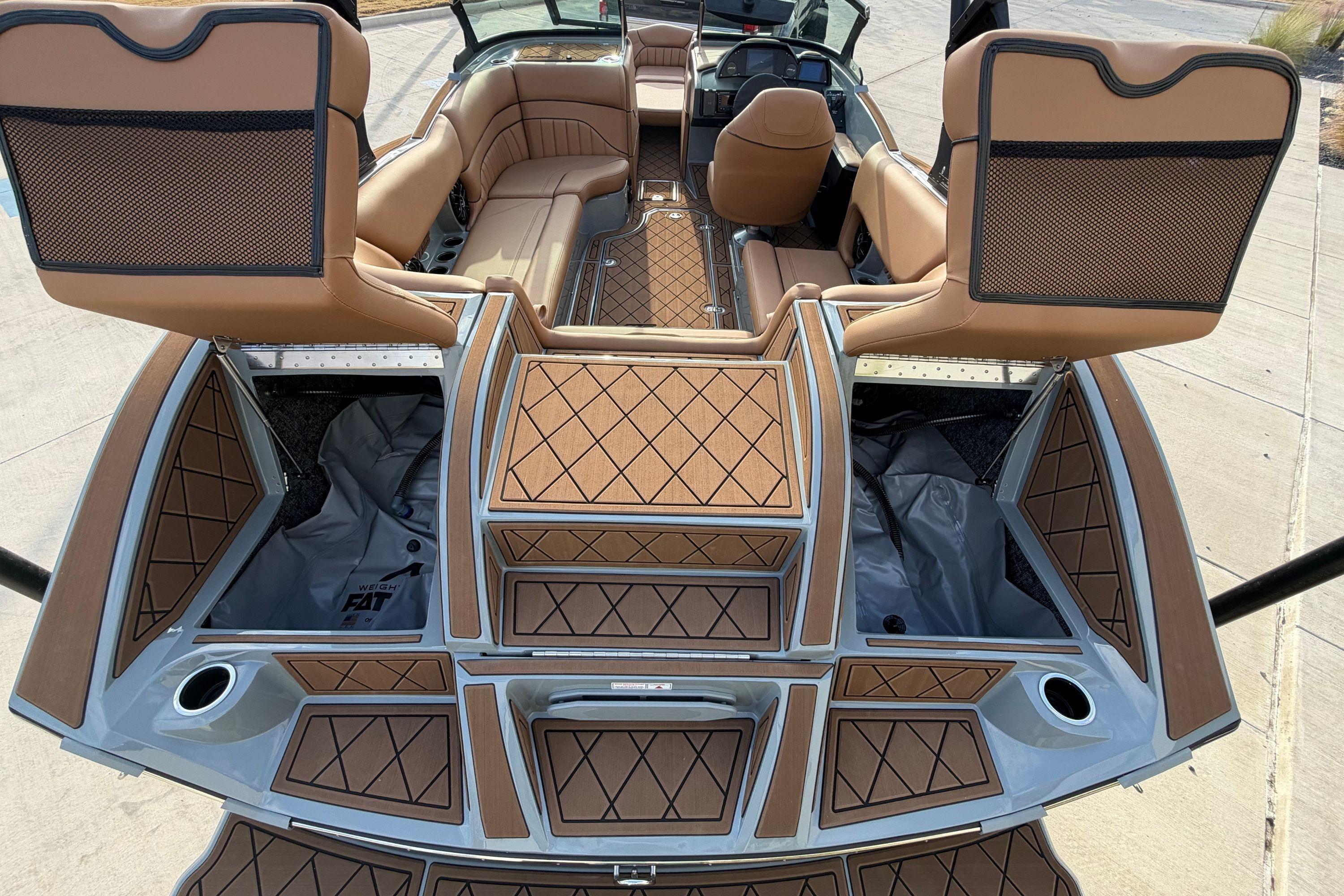 Luxury interior of 2026 MB B52 21 Alpha boat with tan seating and storage compartments.