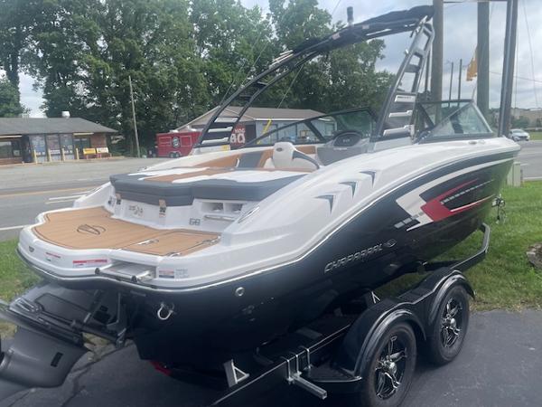 2025 Chaparral 21 SSi boat on trailer, sleek design, parked outdoors.