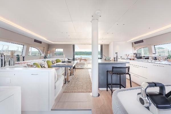 Luxurious interior of 2025 Lagoon SIXTY 5 yacht with modern furnishings and panoramic windows.