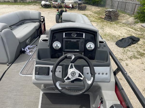 2023 Regency 250DL3 boat dashboard with steering wheel and control panel.