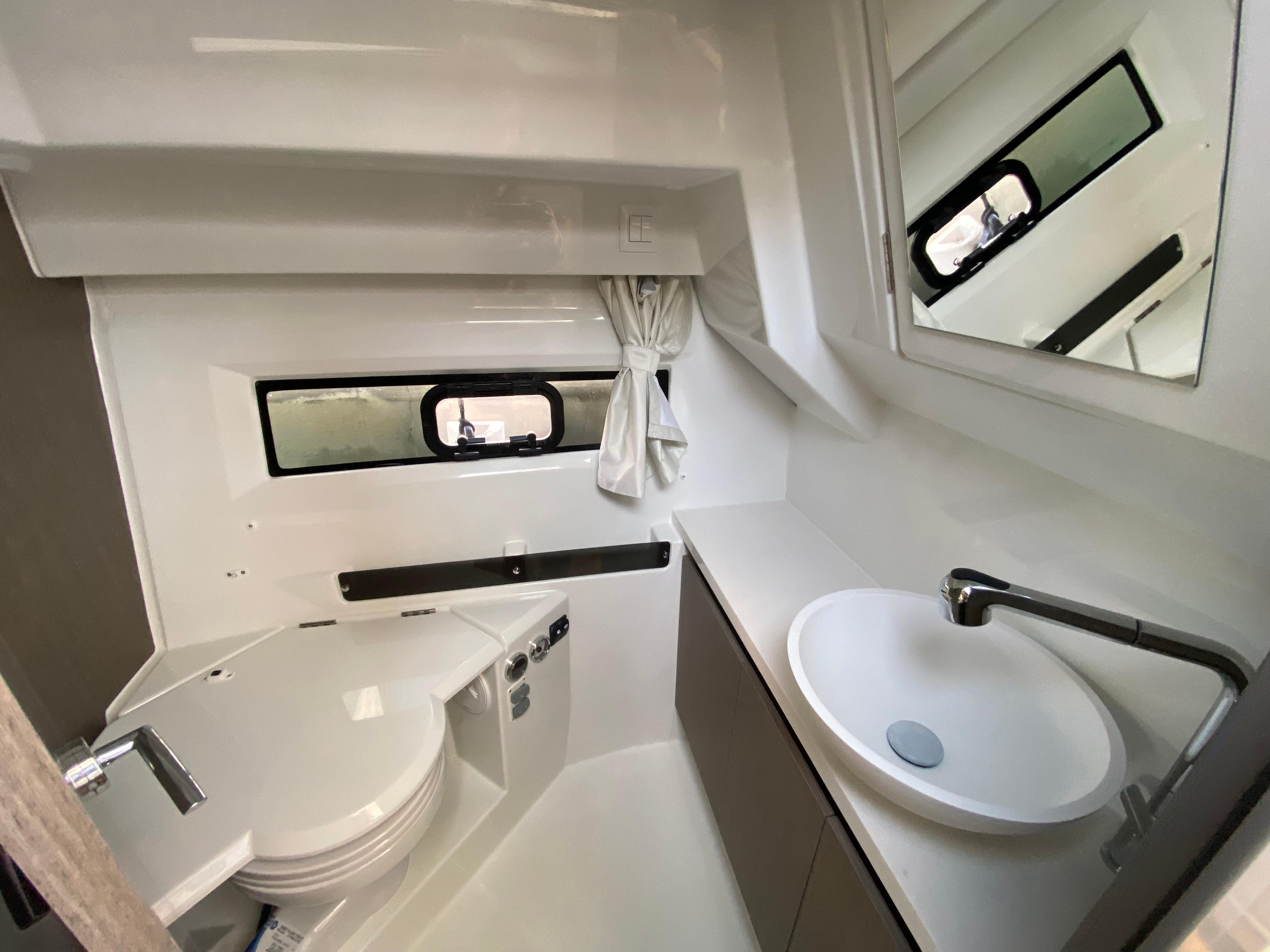 Modern bathroom in 2025 Jeanneau MERRY FISHER 895 S2 boat, featuring sleek design and compact fixtures.