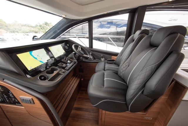 2024 Princess V55 yacht cockpit with leather seats and advanced navigation displays.