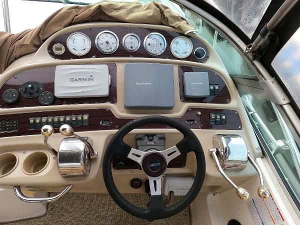2004 Chaparral Signature 350 boat dashboard with Garmin and Raymarine navigation systems.