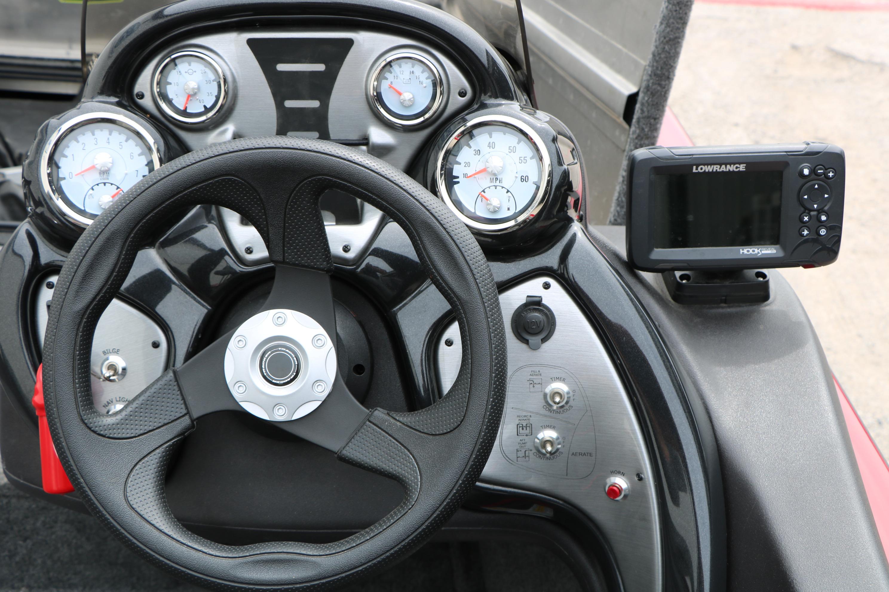 2024 Tracker Pro Team 175 dashboard with steering wheel and Lowrance fishfinder.