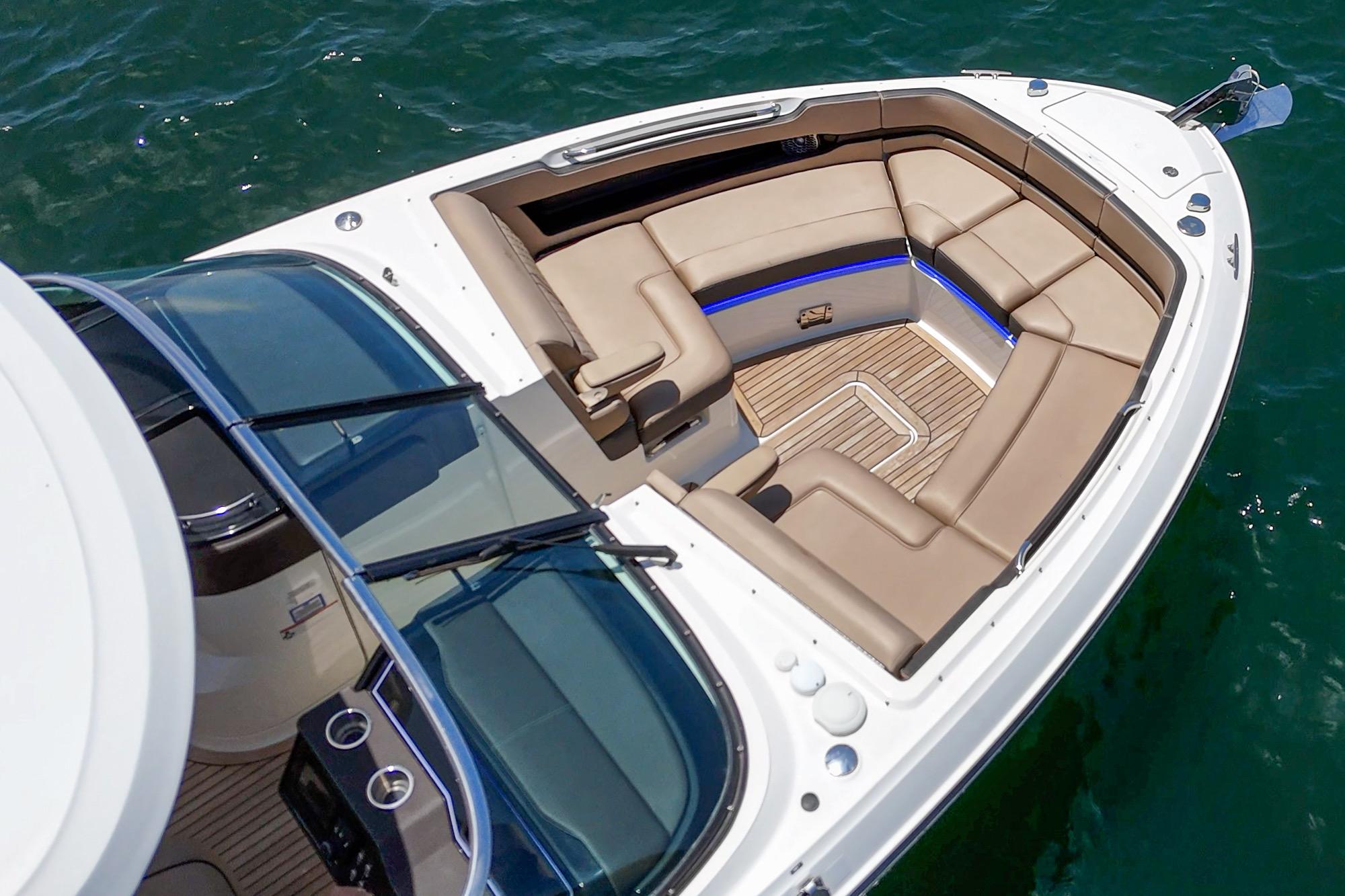 2018 Sea Ray SLX 310 boat with luxurious seating on calm water.