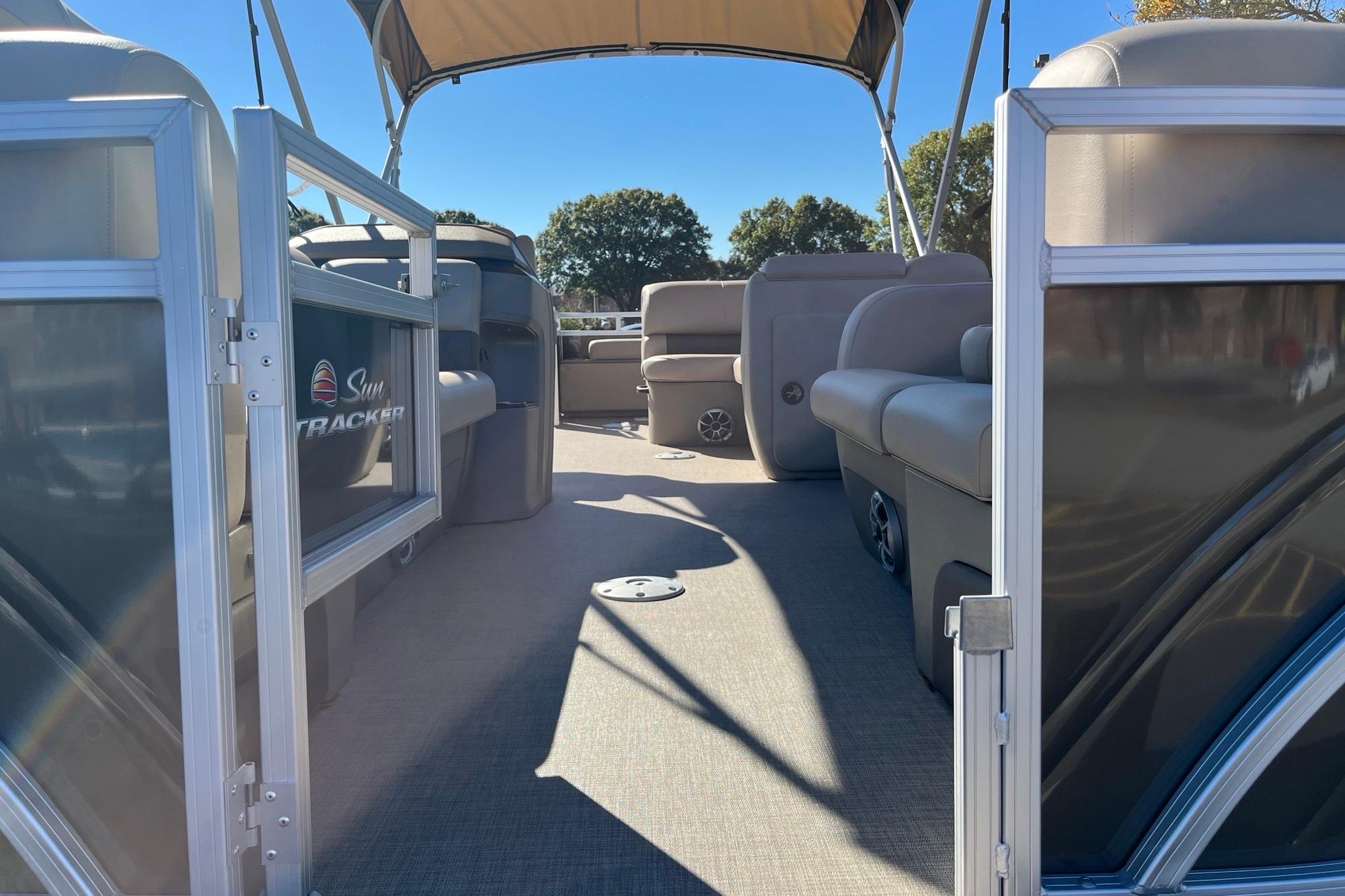 2025 Sun Tracker SportFish 22 DLX pontoon boat interior with seating and canopy.