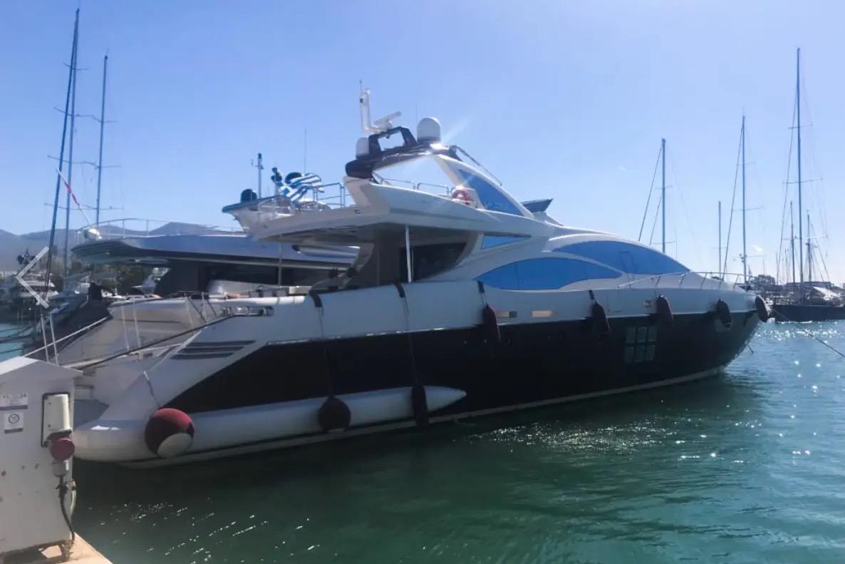 Luxury 2009 Azimut 103S yacht docked in a sunny marina.